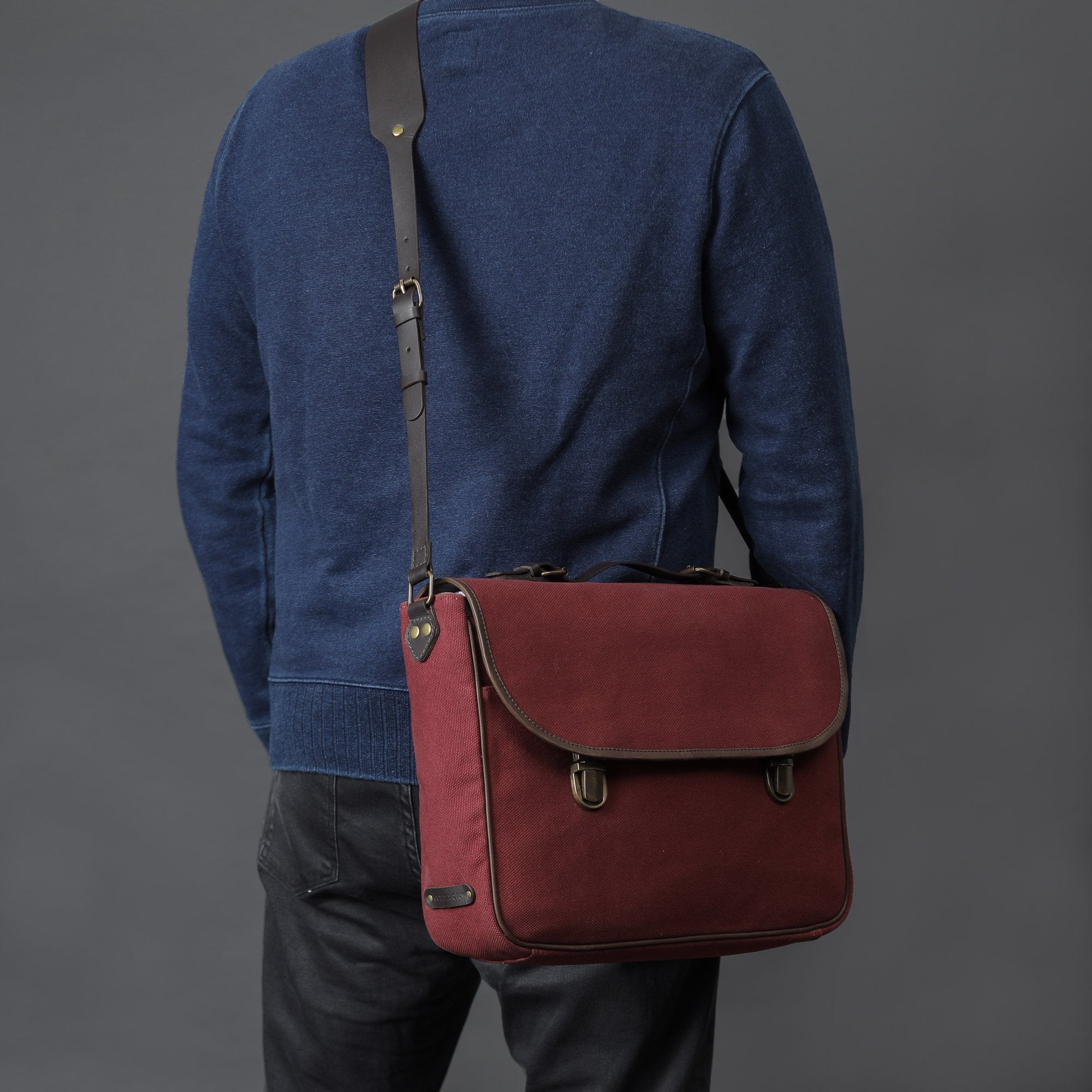 London Canvas Briefcase made from durable cotton canvas with leather straps, featuring a laptop compartment and multiple pockets.