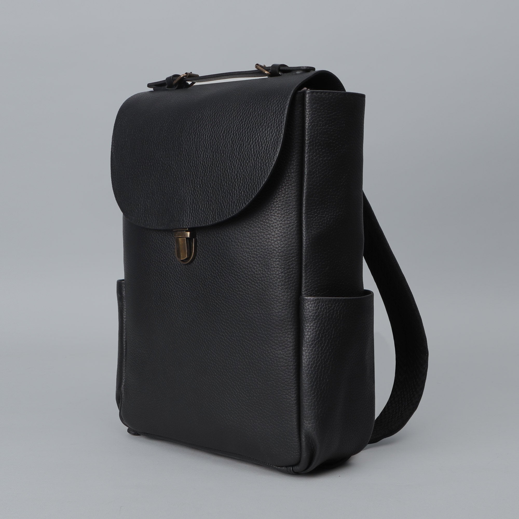 London Leather Backpack made from premium full grain leather, featuring multiple pockets, adjustable straps, and a spacious design for laptops.