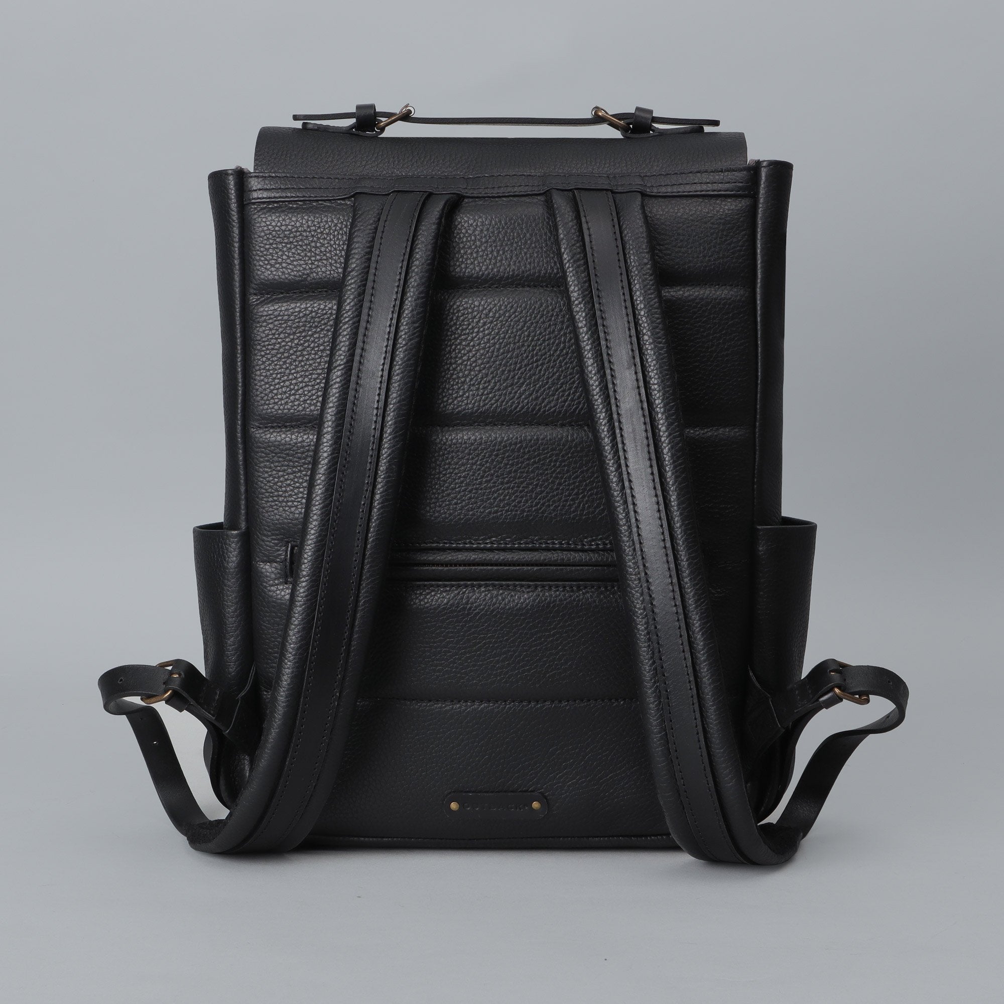 London Leather Backpack made from premium full grain leather, featuring multiple pockets, adjustable straps, and a spacious design for laptops.