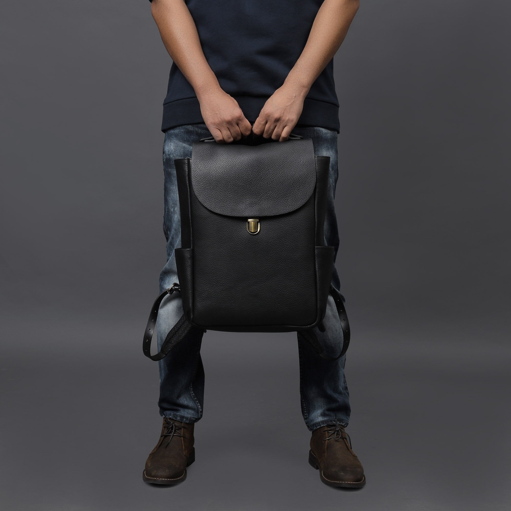 London Leather Backpack made from premium full grain leather, featuring multiple pockets, adjustable straps, and a spacious design for laptops.