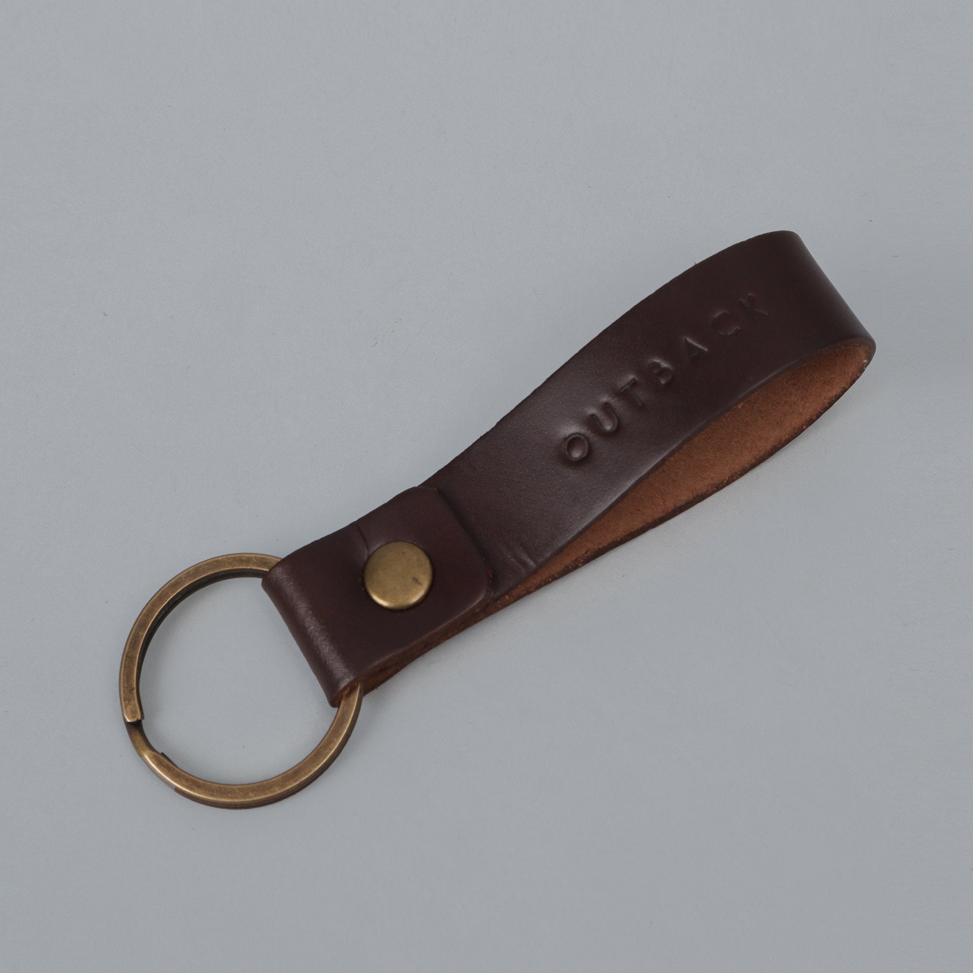 Loop Key Holder made from durable harness leather with antique brass hardware, showcasing its elegant design and craftsmanship.