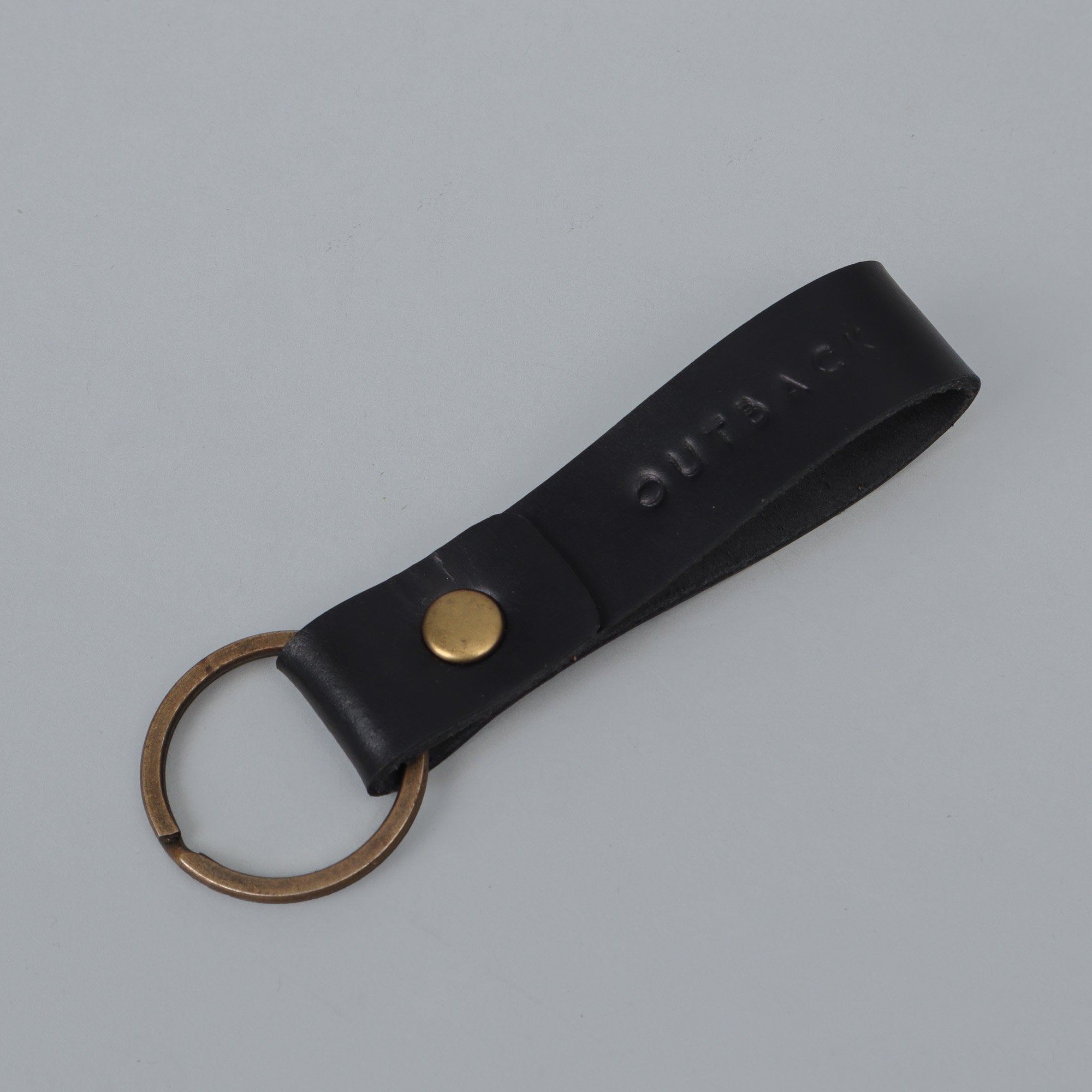 Loop Key Holder made from durable harness leather with antique brass hardware, showcasing its elegant design and craftsmanship.