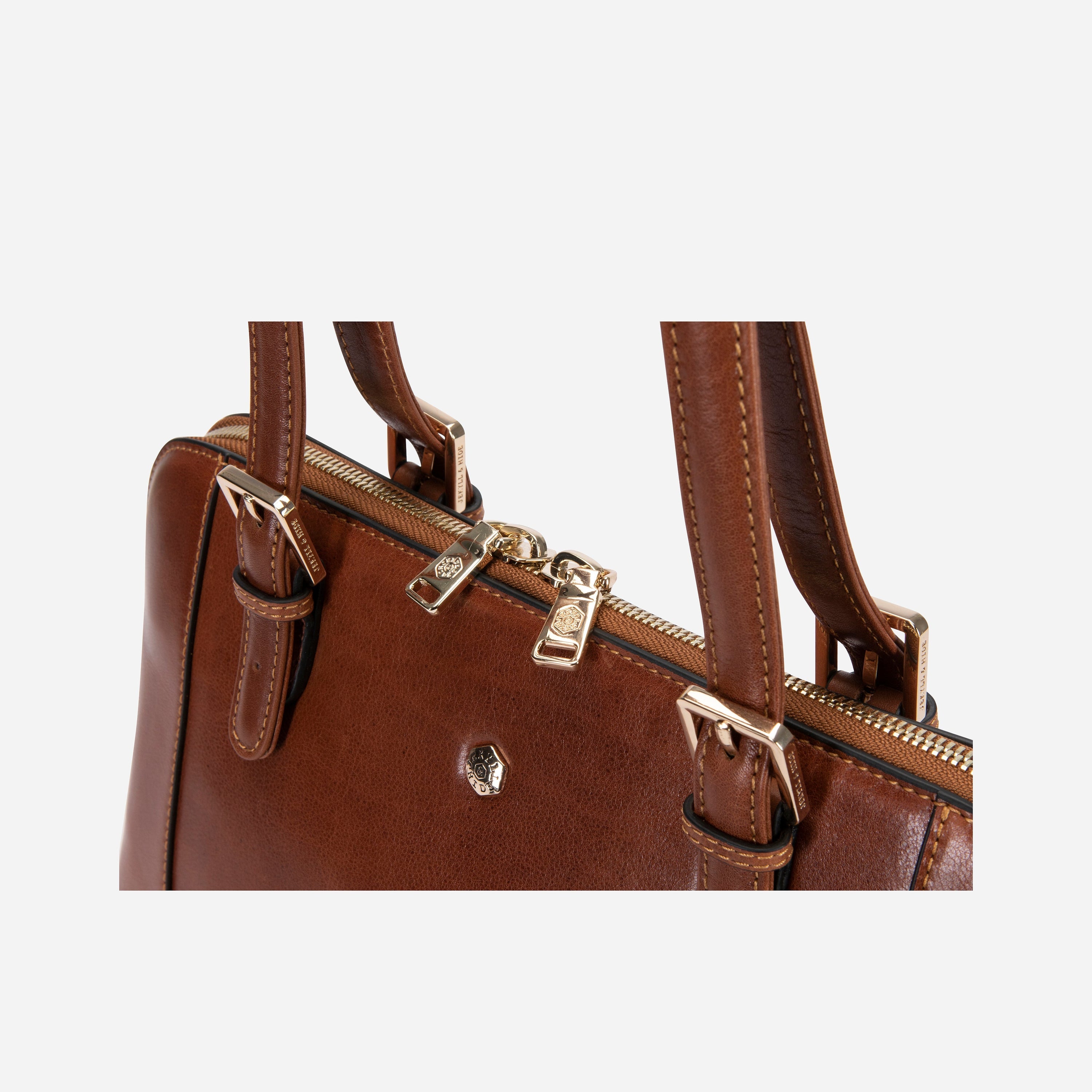 Madrid Handbag in Tan with adjustable straps and multiple pockets, showcasing its elegant design and ample space.