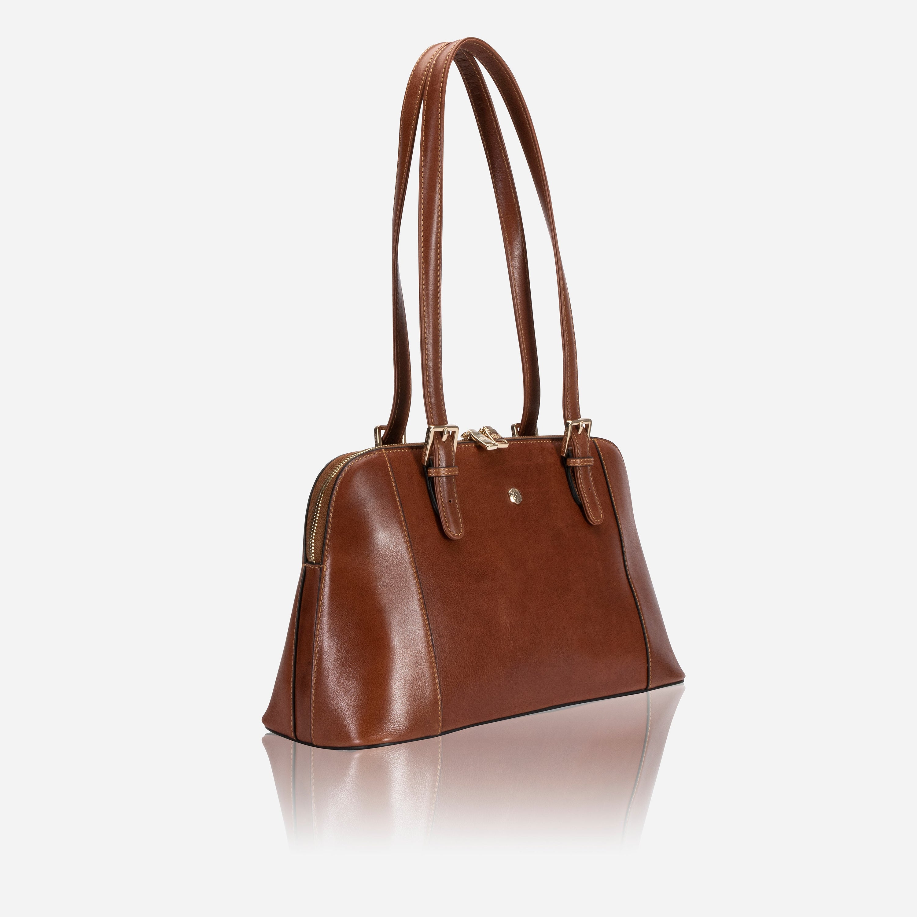 Madrid Handbag in Tan with adjustable straps and multiple pockets, showcasing its elegant design and ample space.