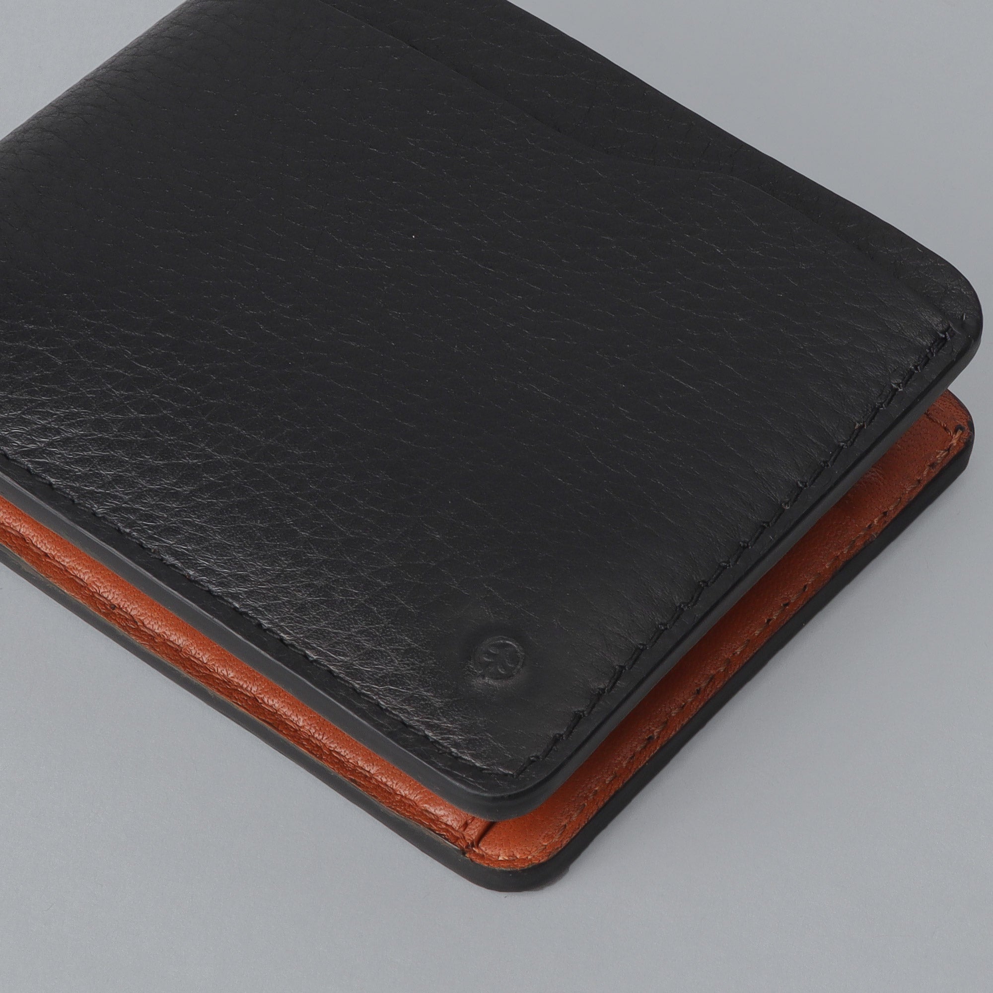 Max Wallet made from premium full grain leather with multiple pockets for cards and cash, featuring antique brass hardware.