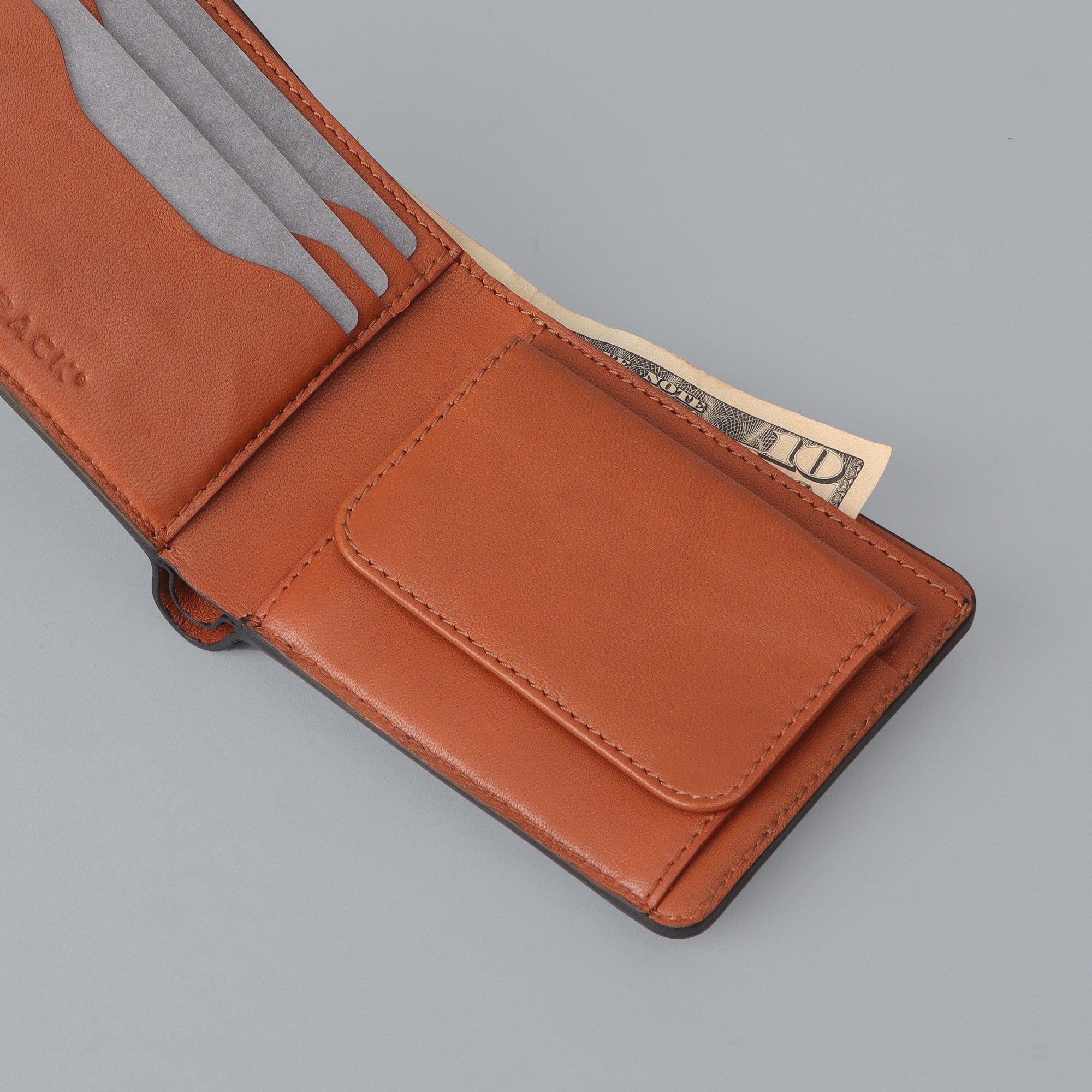 Max Wallet made from premium full grain leather with multiple pockets for cards and cash, featuring antique brass hardware.