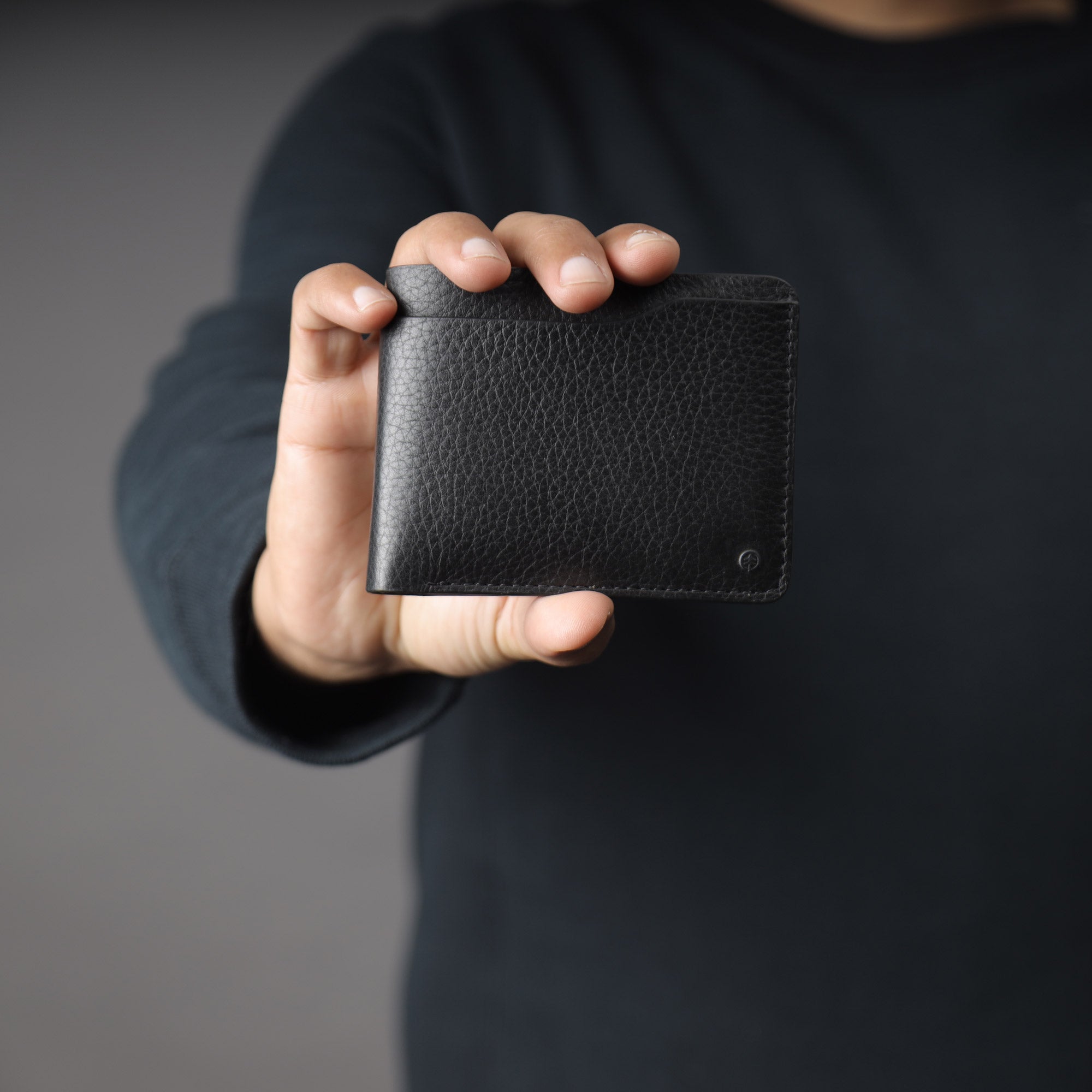 Max Wallet made from premium full grain leather with multiple pockets for cards and cash, featuring antique brass hardware.