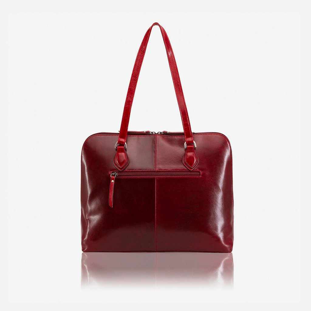 Medium leather laptop handbag in rust color, showcasing its elegant design and spacious interior.