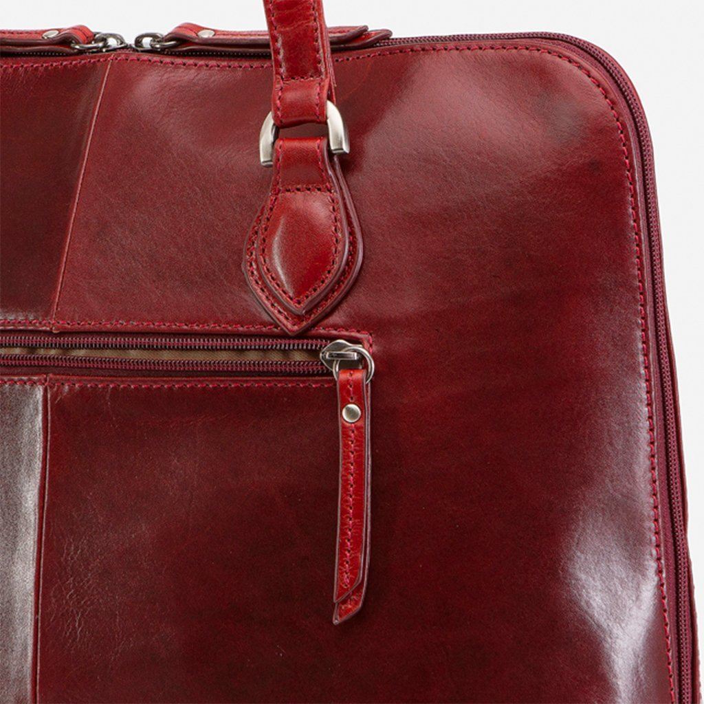 Medium leather laptop handbag in rust color, showcasing its elegant design and spacious interior.