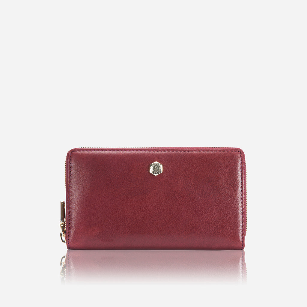 A stylish Medium Zip Around Purse in vibrant red with exclusive Italian prints, showcasing its compact design and zip-around closure.