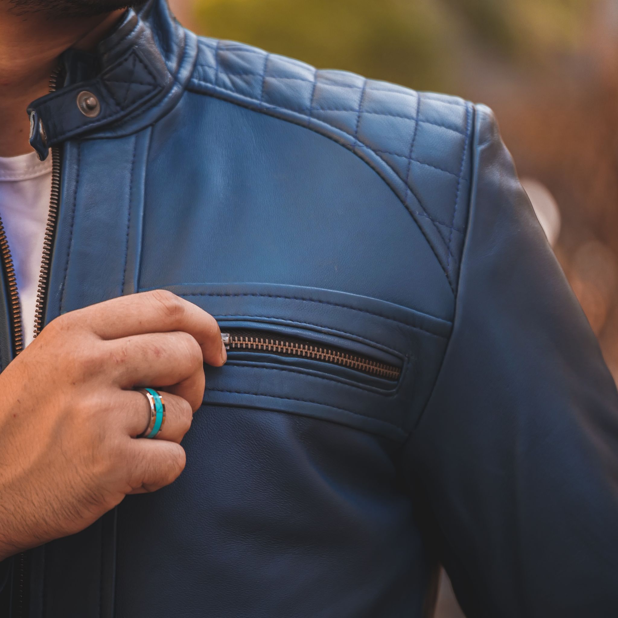 Men's Casual Signature Diamond Lambskin Leather Jacket in Blue, featuring a quilted diamond pattern and multiple zip pockets.