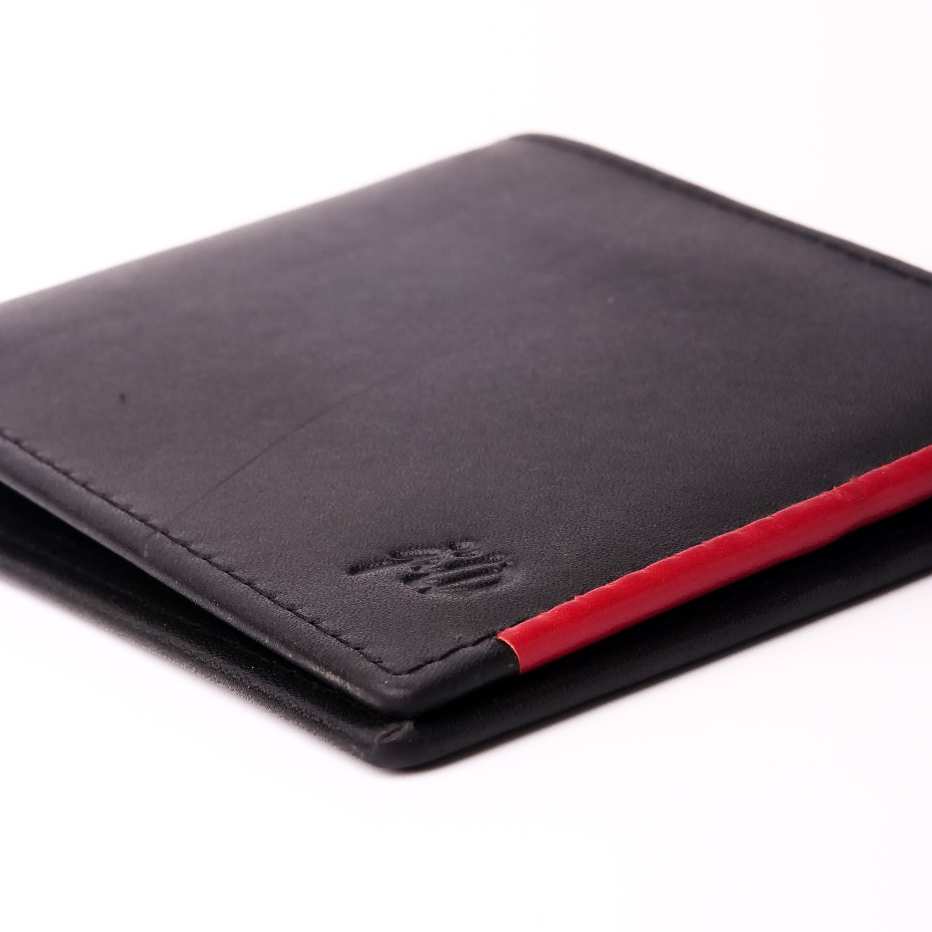 Mens bifold wallet made of pure leather featuring a stylish red stripe, showcasing its slim design and multiple compartments.