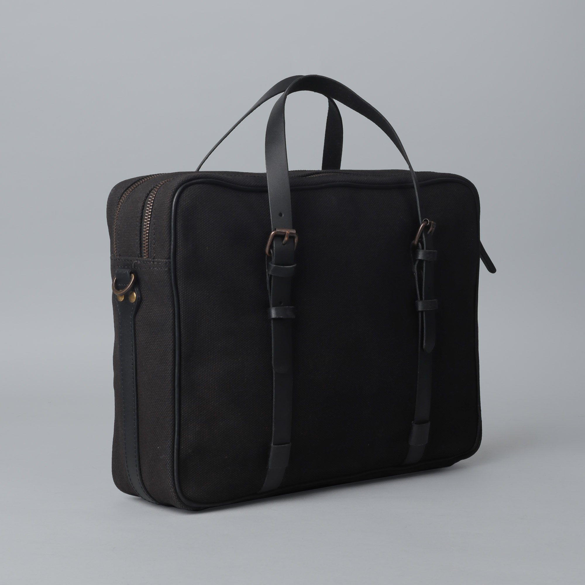 Miami Canvas Briefcase featuring durable cotton canvas, leather straps, and spacious compartments for laptops and essentials.