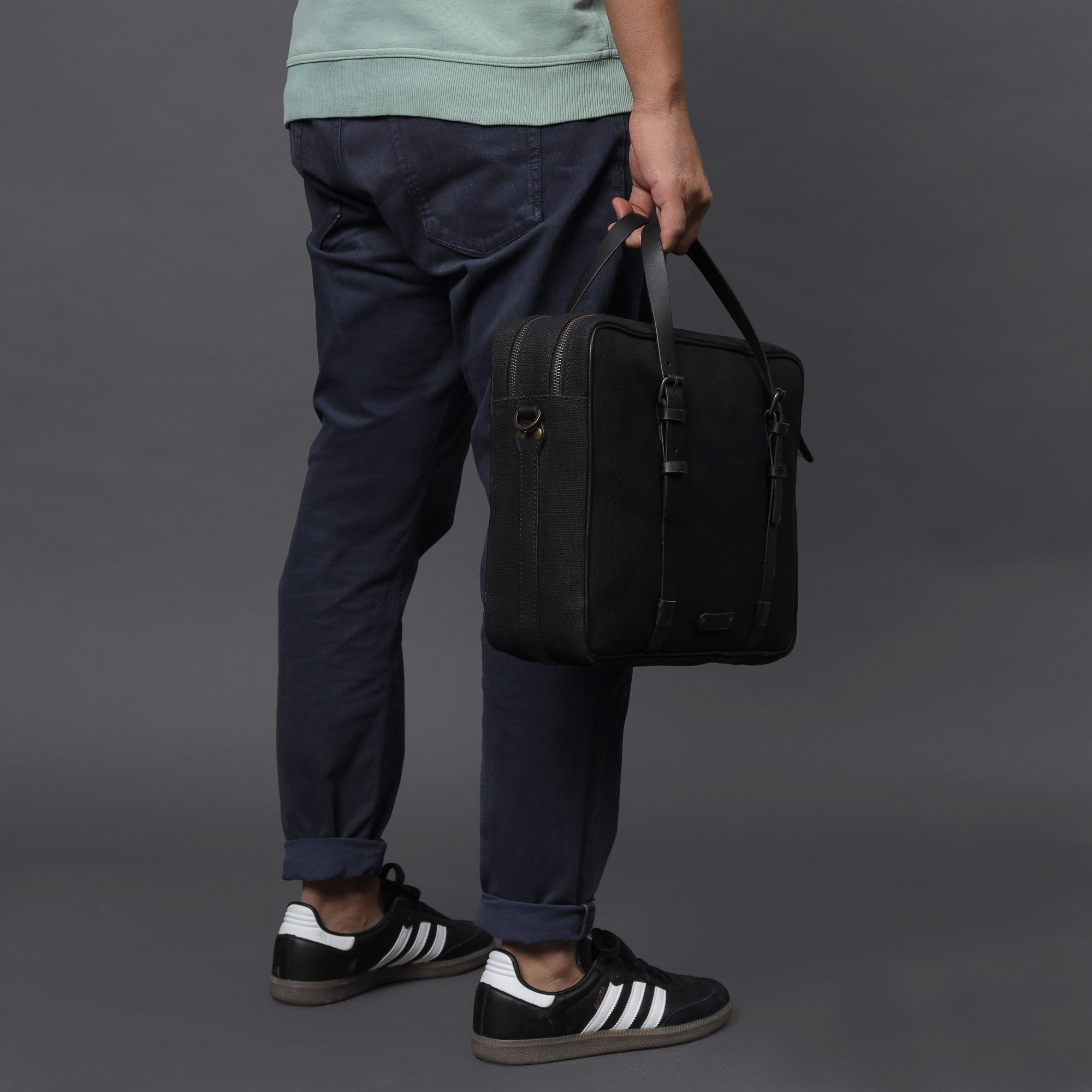 Miami Canvas Briefcase featuring durable cotton canvas, leather straps, and spacious compartments for laptops and essentials.