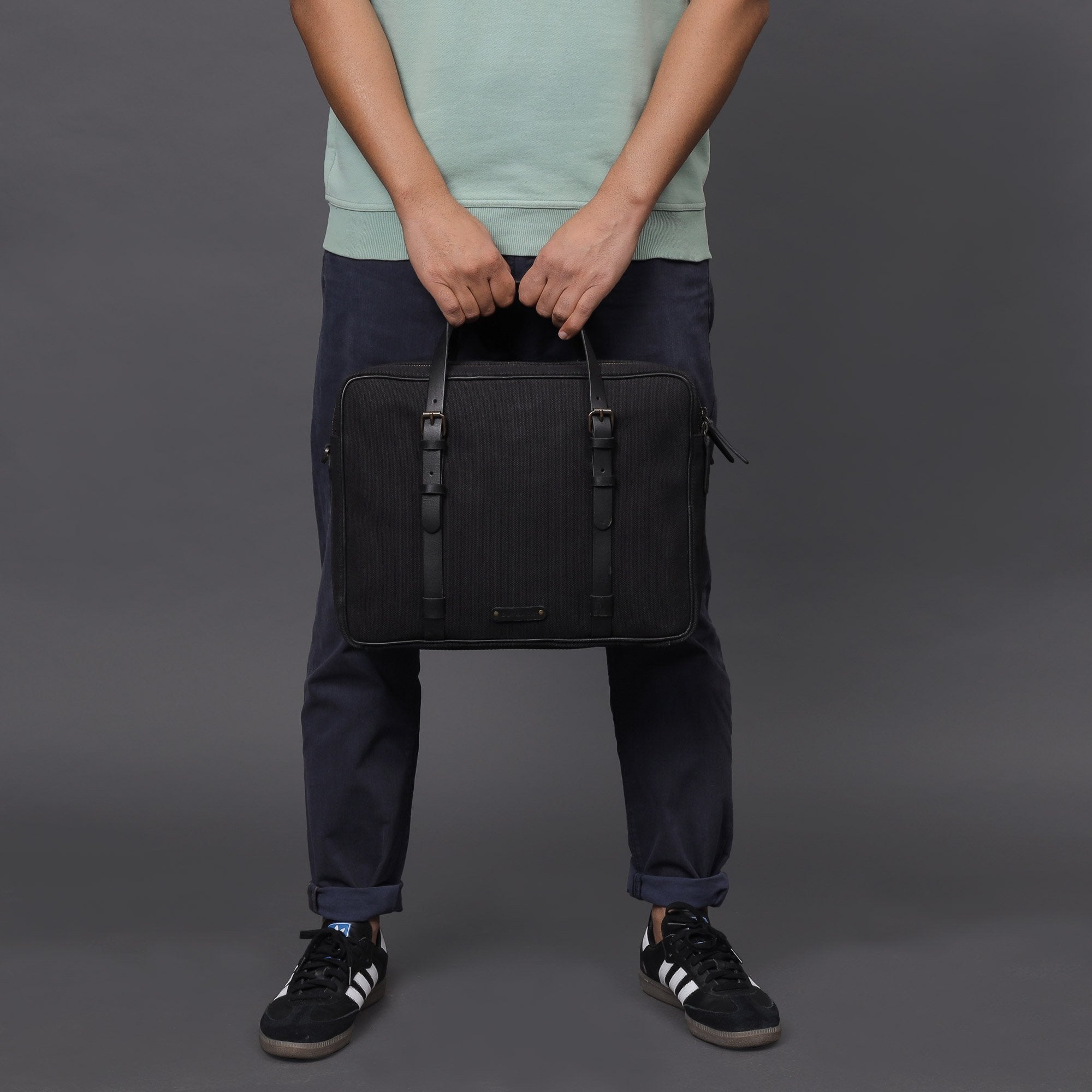 Miami Canvas Briefcase featuring durable cotton canvas, leather straps, and spacious compartments for laptops and essentials.