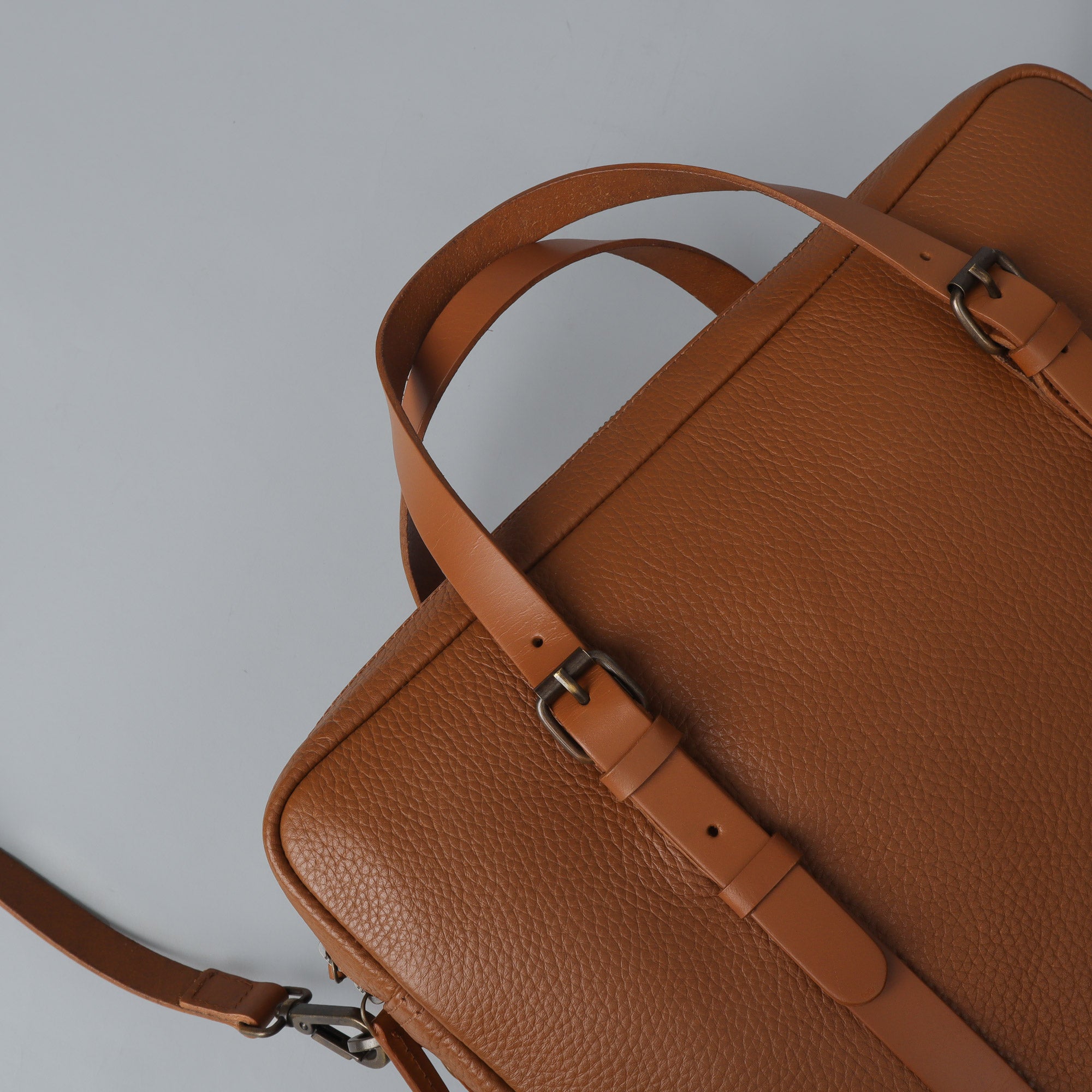 Miami Leather Briefcase showcasing premium full grain leather, spacious compartments, and adjustable shoulder strap.