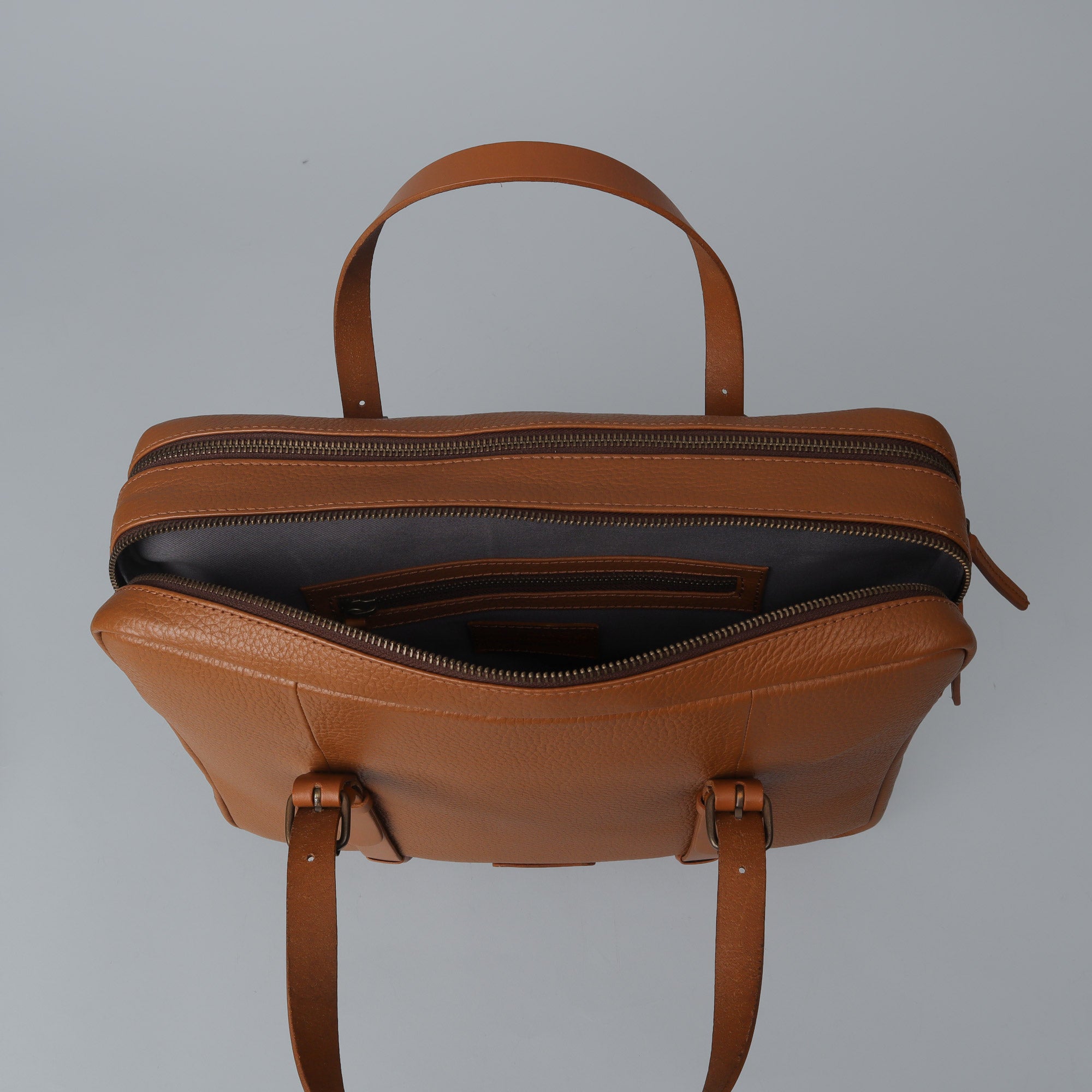 Miami Leather Briefcase showcasing premium full grain leather, spacious compartments, and adjustable shoulder strap.