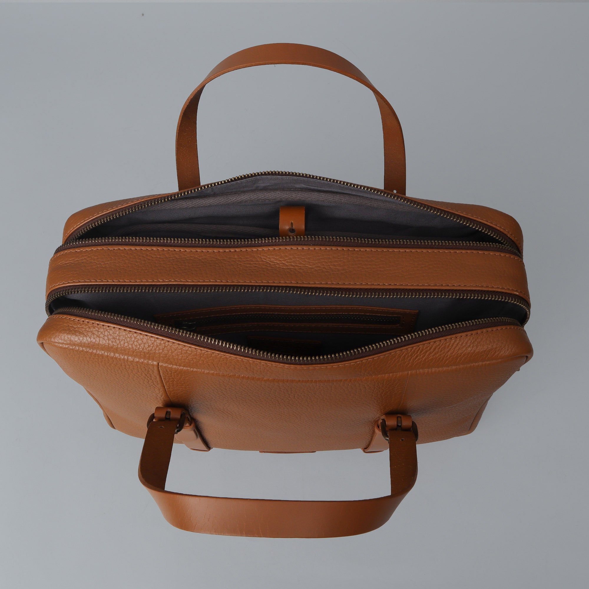 Miami Leather Briefcase showcasing premium full grain leather, spacious compartments, and adjustable shoulder strap.