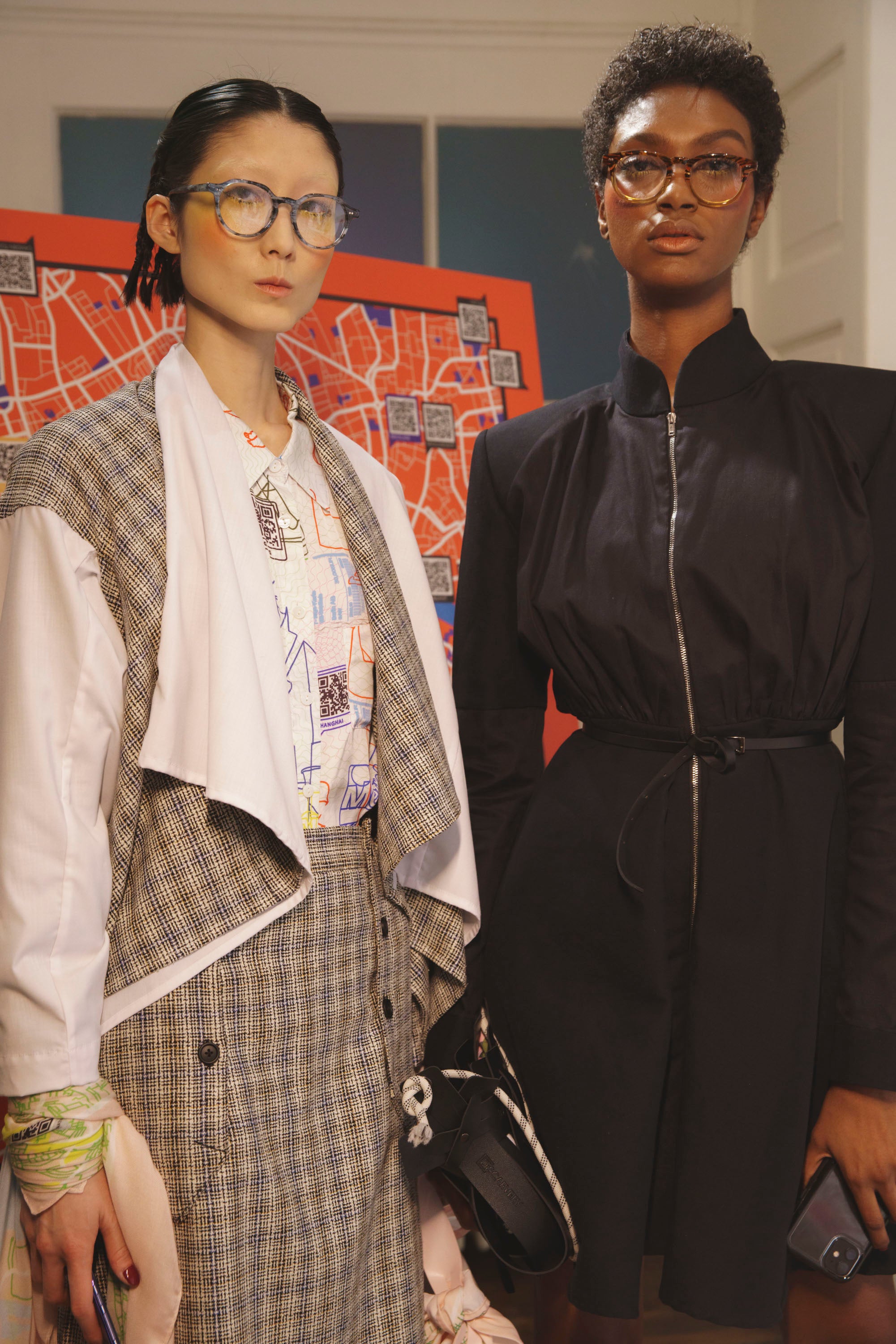 A stylish midi black jacket dress displayed on a mannequin, showcasing its versatile design that can be worn as a dress or opened as a jacket.