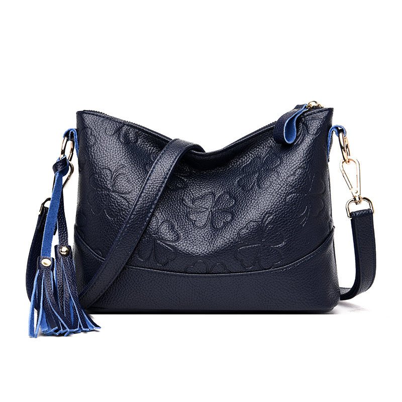 A stylish small messenger bag for middle-aged women featuring a chic tassel design, made from durable PU fabric.