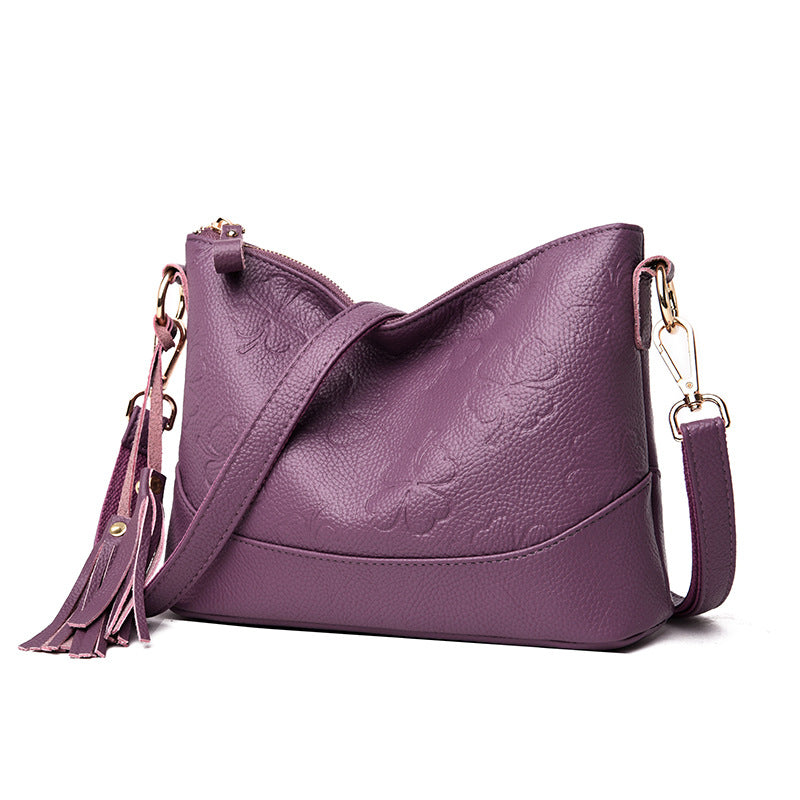 A stylish small messenger bag for middle-aged women featuring a chic tassel design, made from durable PU fabric.