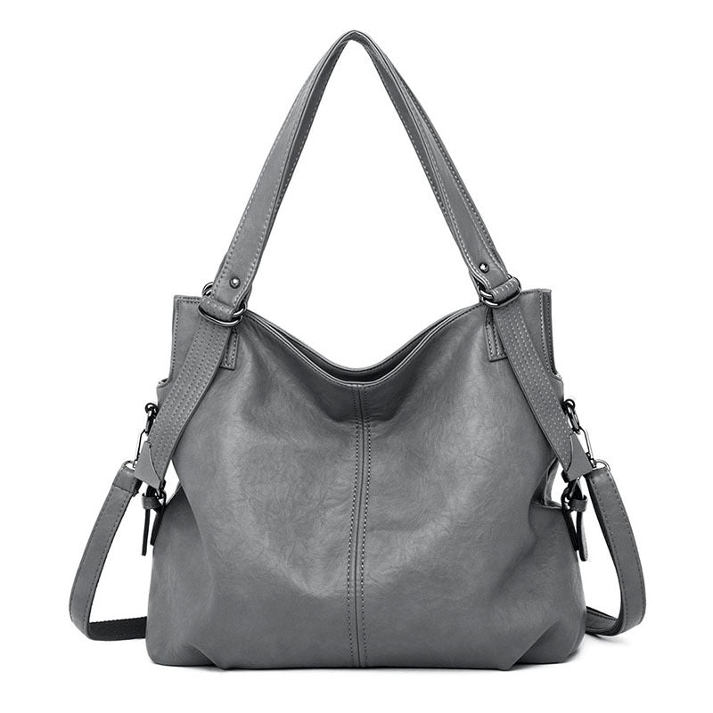 A stylish middle-aged women's vintage PU leather messenger bag in a square shape, featuring a soft handle and a plain pattern, ideal for everyday use.