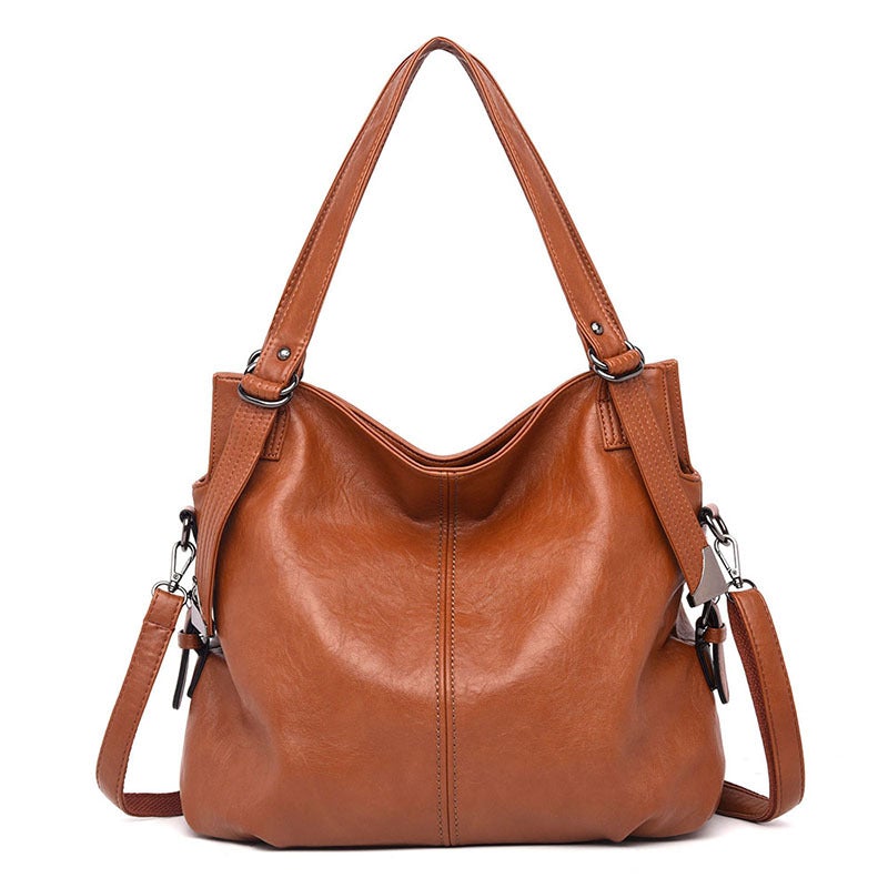 A stylish middle-aged women's vintage PU leather messenger bag in a square shape, featuring a soft handle and a plain pattern, ideal for everyday use.