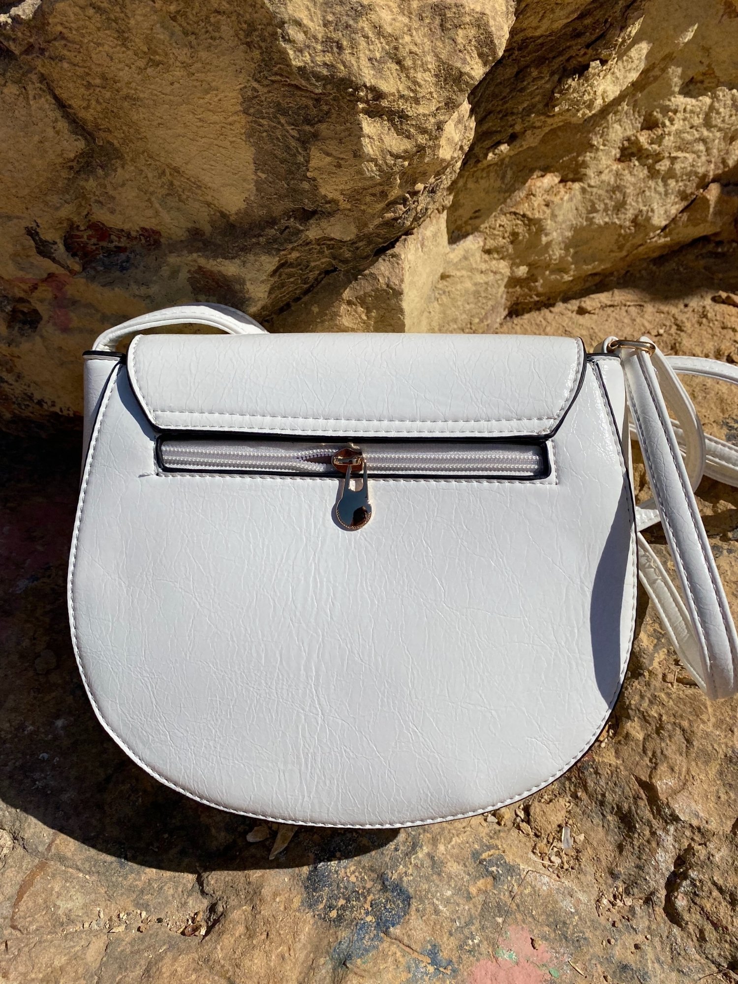 Mini Bag with Buckle in neutral colors featuring shiny gold-toned hardware and a spacious interior.