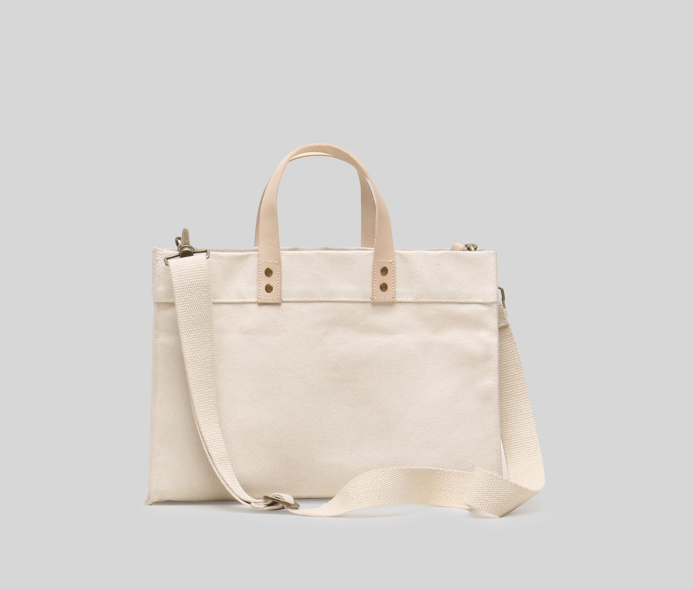 Mini Box Tote Bag featuring heavyweight canvas, thick leather handle, and metal studs for a high-end look.