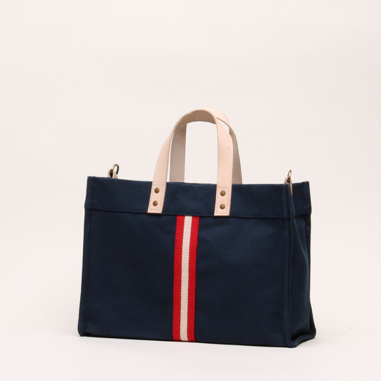 Mini Box Tote Bag featuring heavyweight canvas, thick leather handle, and metal studs for a high-end look.