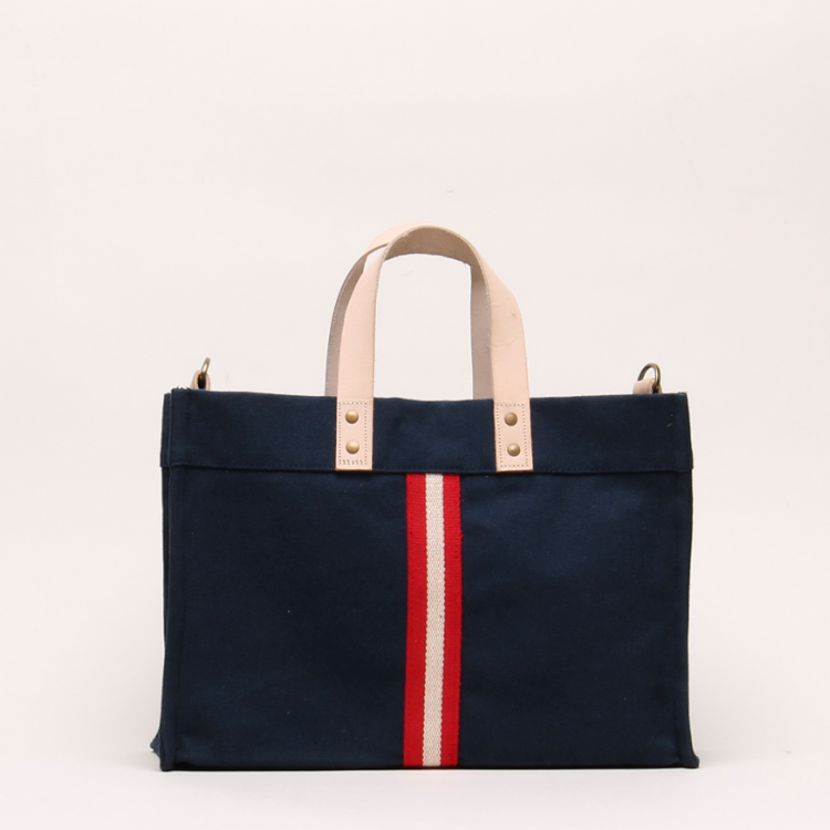 Mini Box Tote Bag featuring heavyweight canvas, thick leather handle, and metal studs for a high-end look.