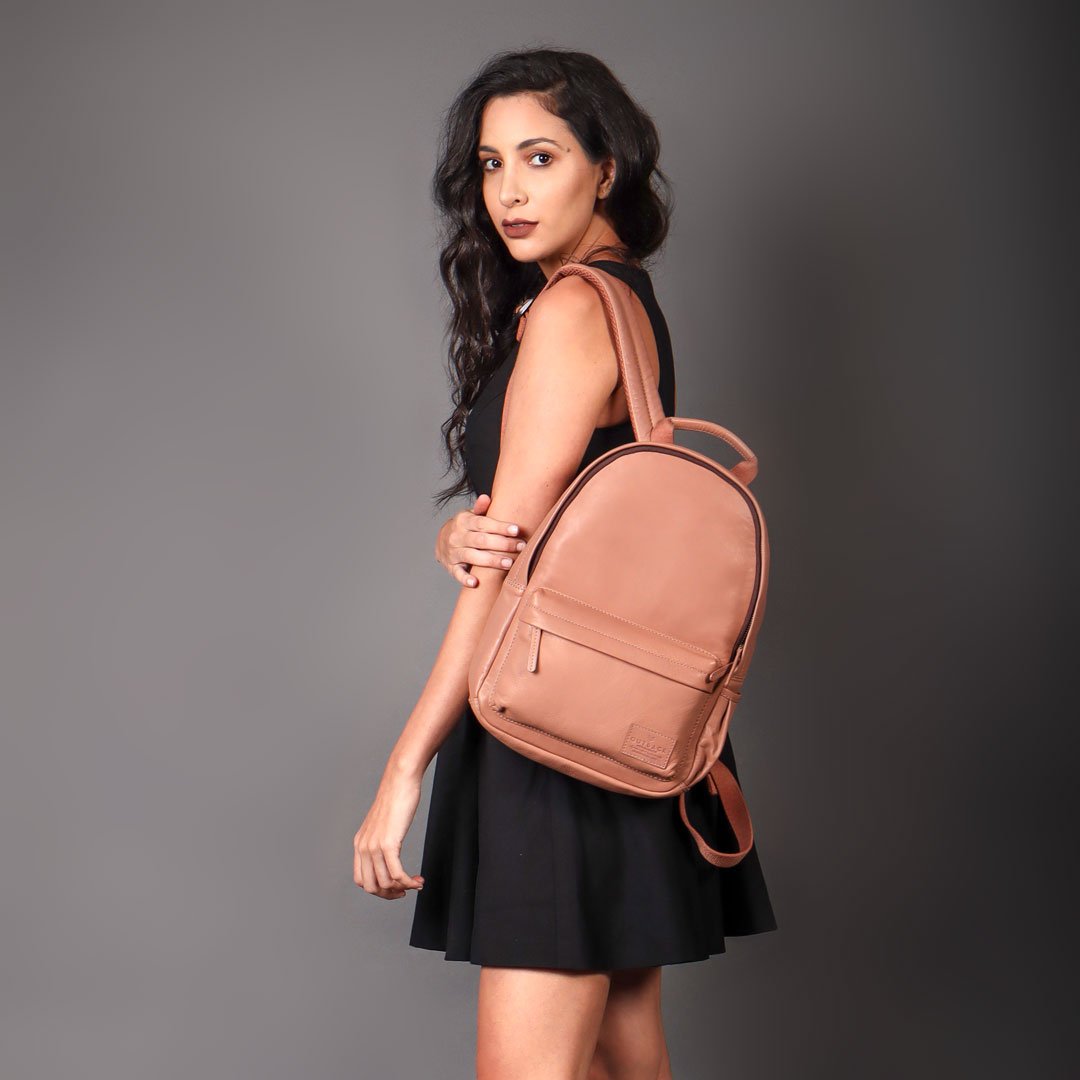 Mini Journey Leather Backpack made from premium full grain leather, featuring adjustable straps and multiple pockets for convenience.