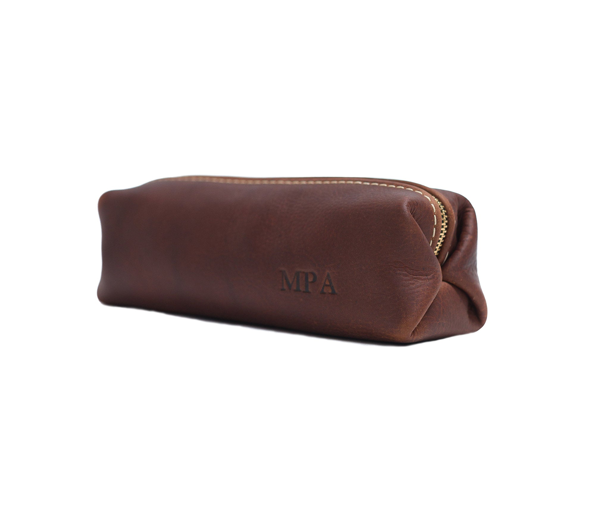 A stylish Minimalist Shave Bag made from premium leather, featuring a durable nylon lining and a brass zipper, perfect for travel.