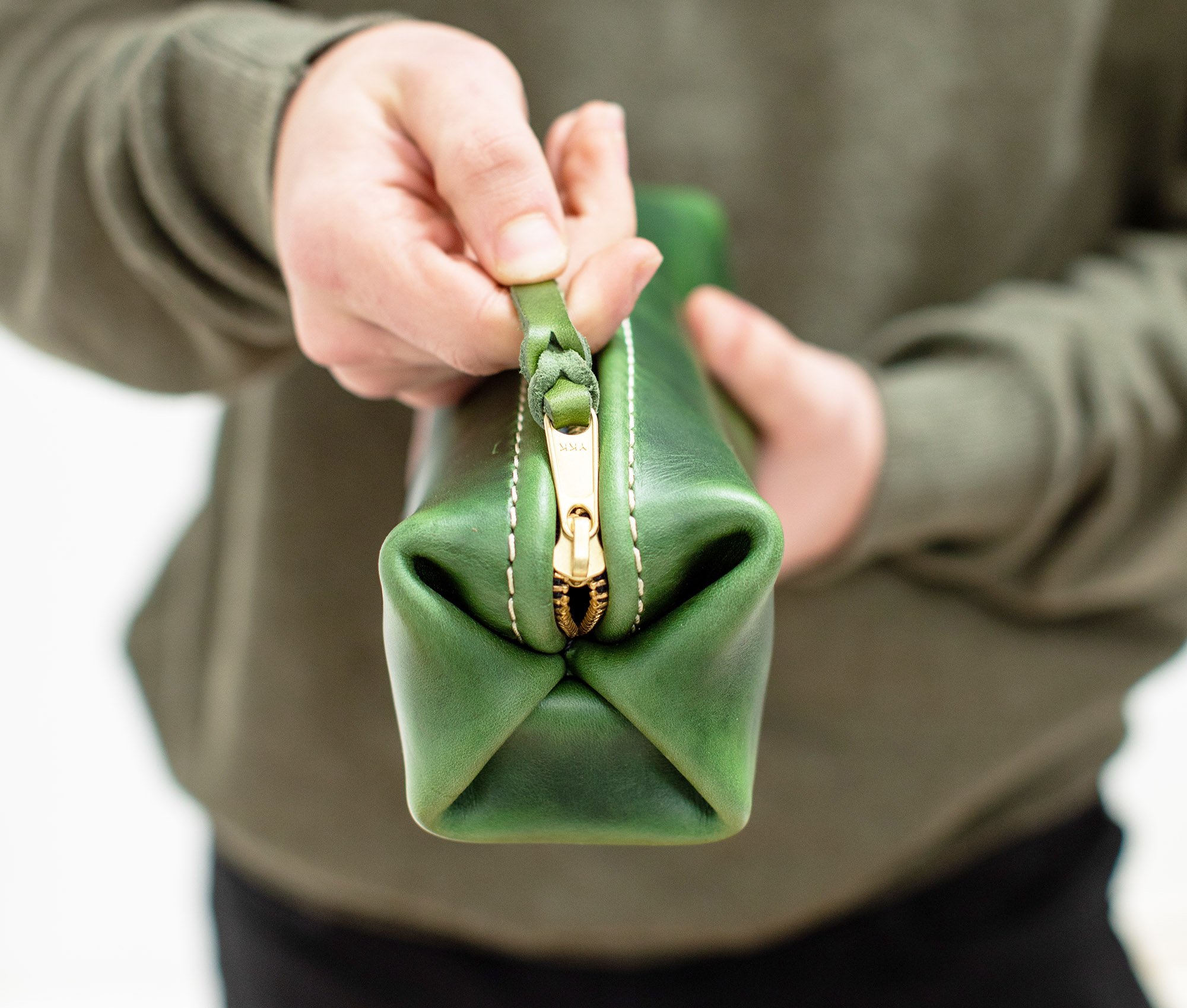 A stylish Minimalist Shave Bag made from premium leather, featuring a durable nylon lining and a brass zipper, perfect for travel.