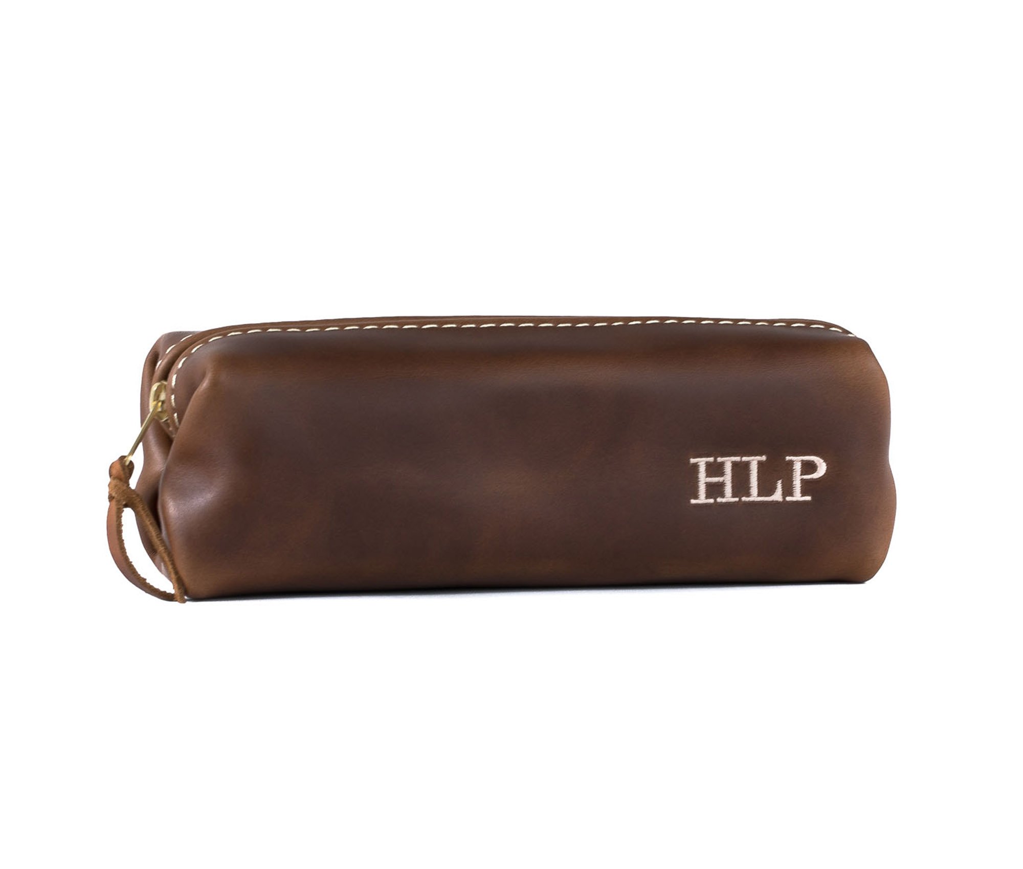 A stylish Minimalist Shave Bag made from premium leather, featuring a durable nylon lining and a brass zipper, perfect for travel.