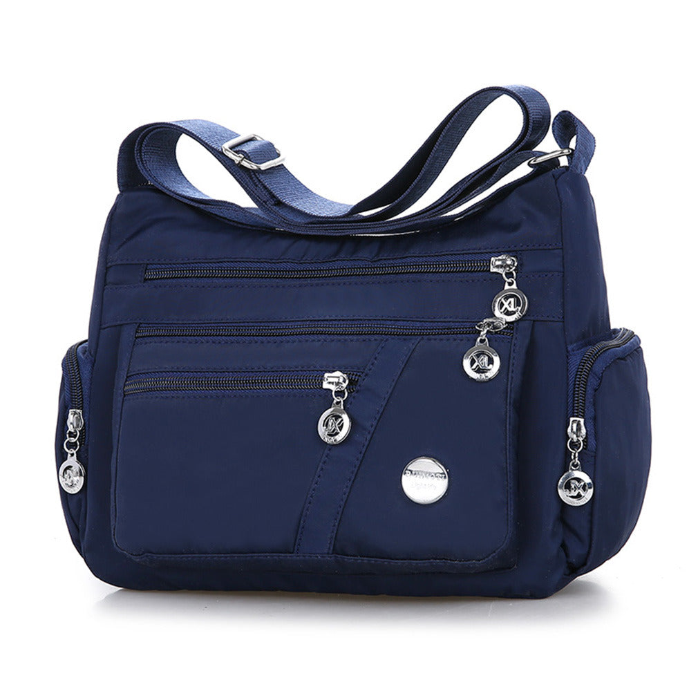 Multi-Compartment Casual One-Shoulder Messenger Bag in Oxford fabric with zipper opening and telescopic handle.