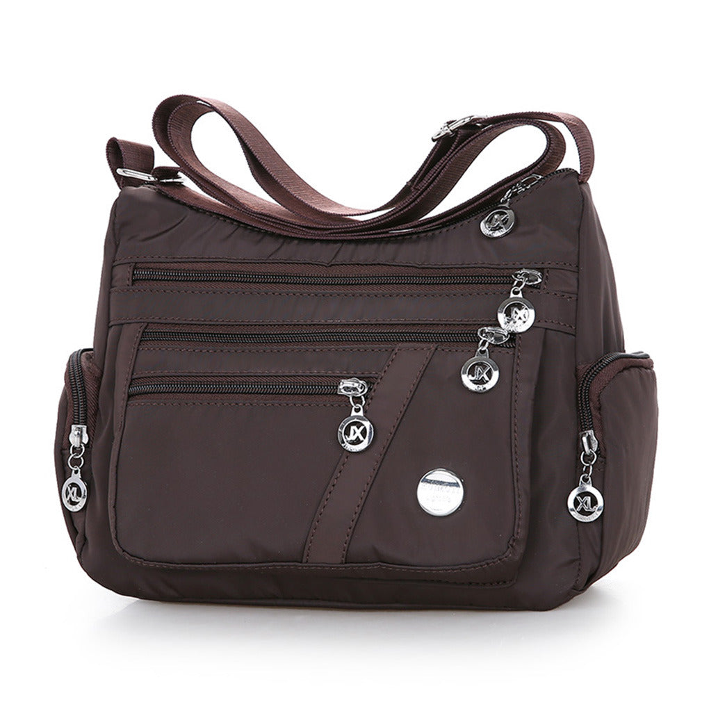 Multi-Compartment Casual One-Shoulder Messenger Bag in Oxford fabric with zipper opening and telescopic handle.