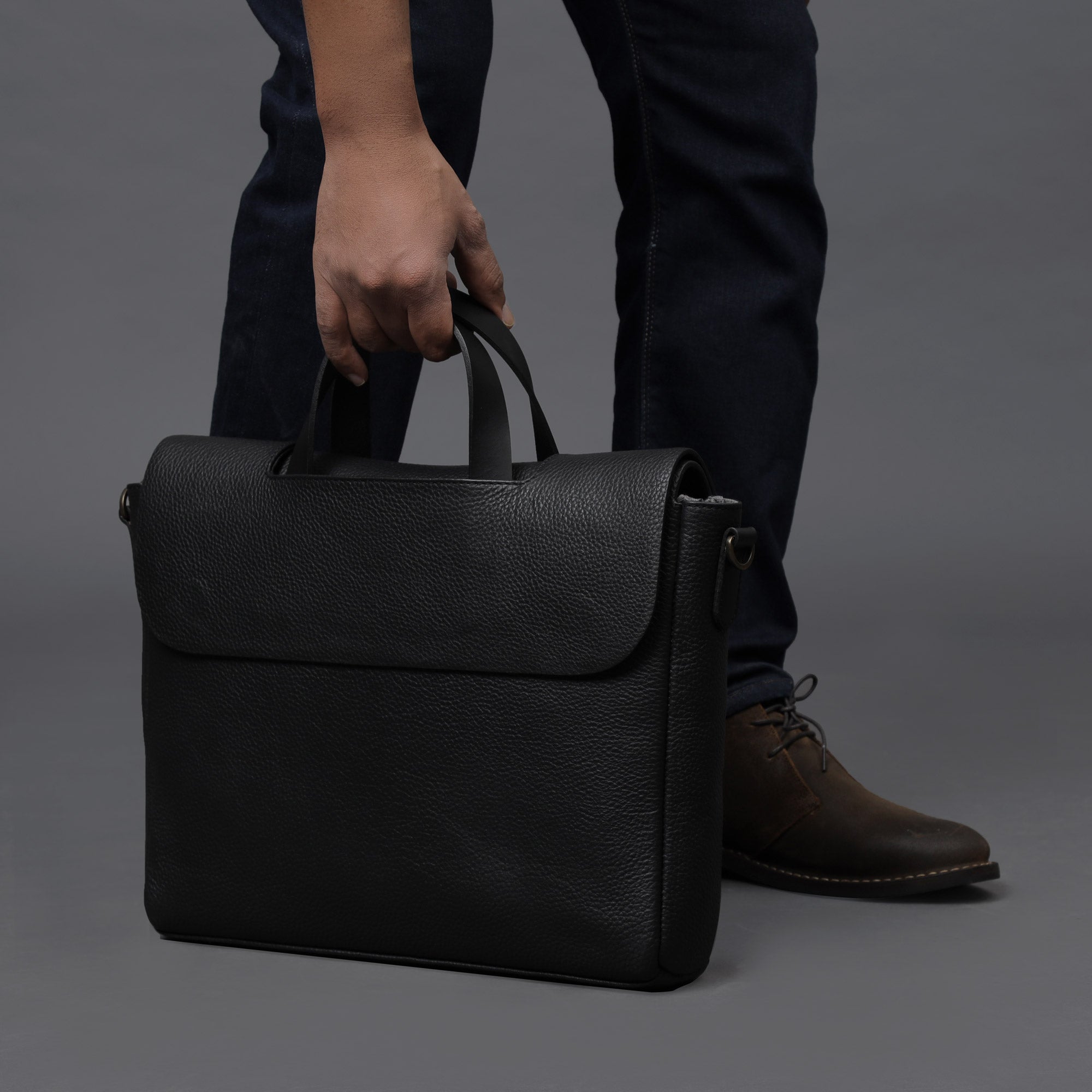 Muse Leather Briefcase made from premium full grain leather, featuring a separate laptop compartment, zipper pocket, and magnetic closure.