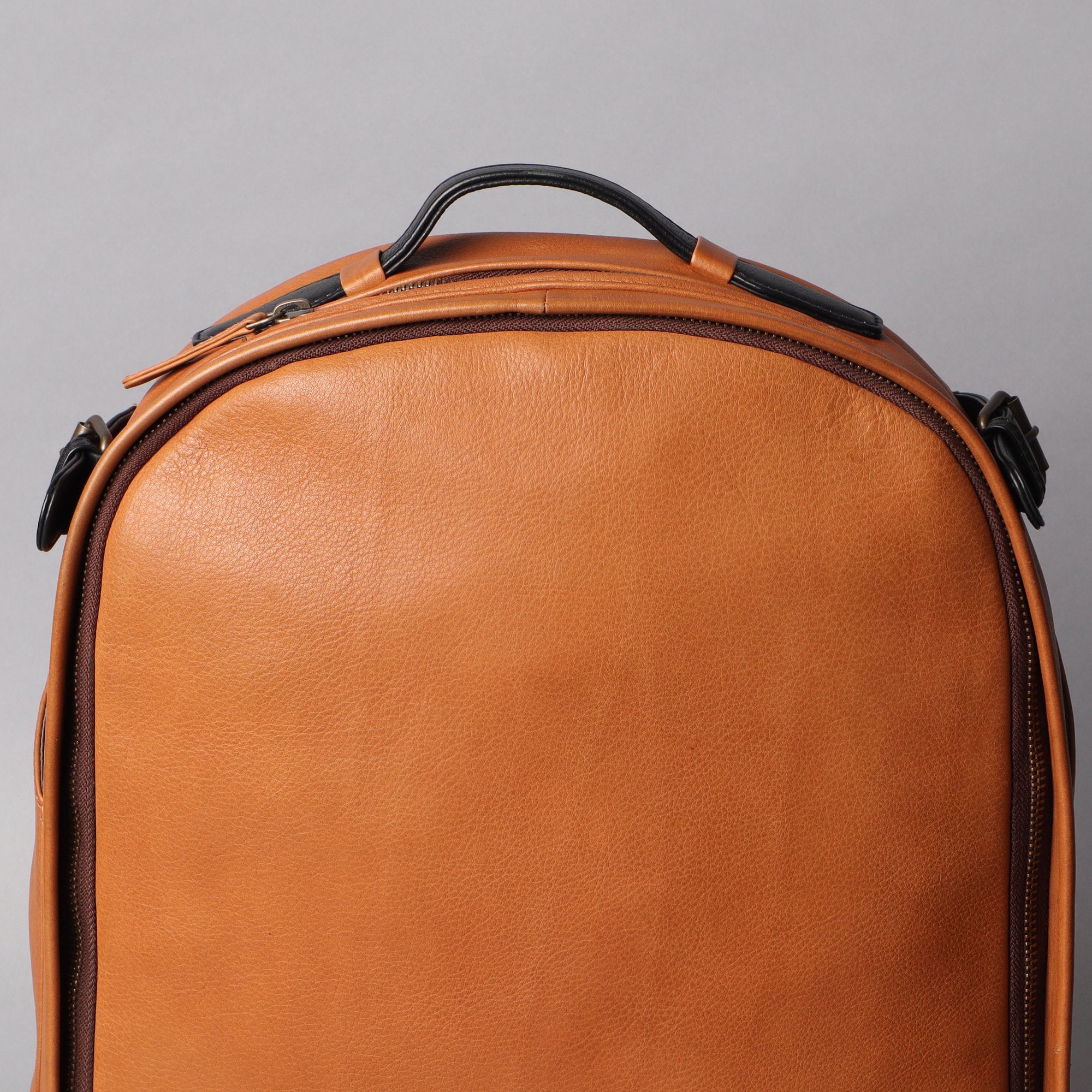 Mustang Leather Backpack showcasing premium full-grain leather, multiple pockets, and adjustable straps.