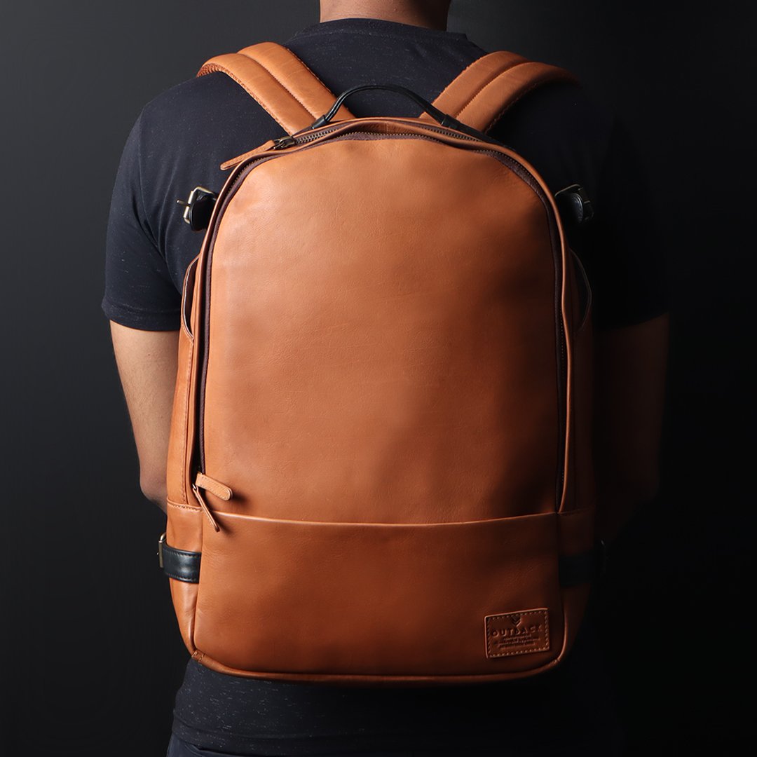 Mustang Leather Backpack showcasing premium full-grain leather, multiple pockets, and adjustable straps.