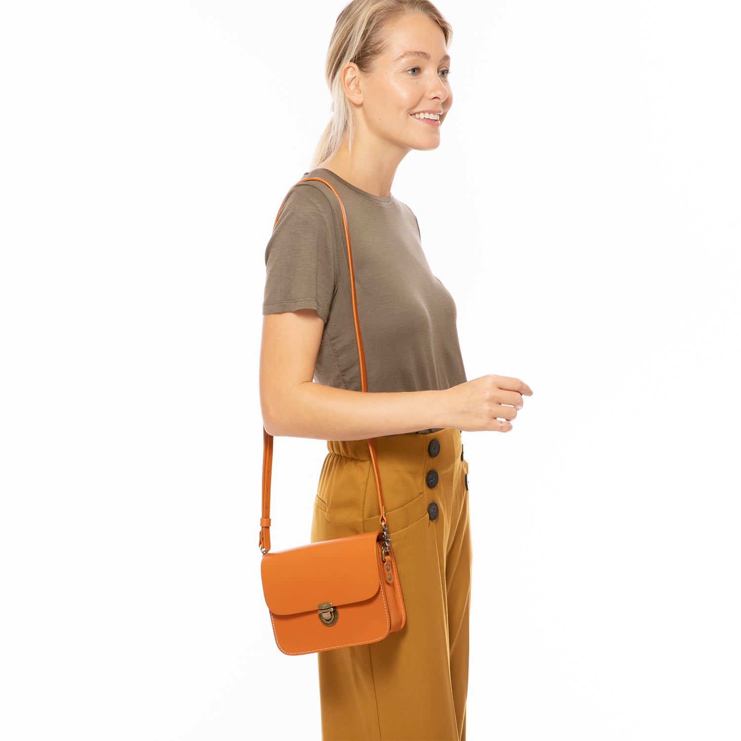 Nanah Light Brown Leather Crossbody Bag with adjustable strap and bronze hardware, showcasing its vintage-inspired design.