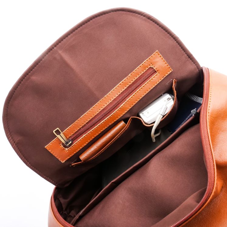 Tan brown On-The-Go Leather Backpack showcasing its sleek design and multiple compartments.