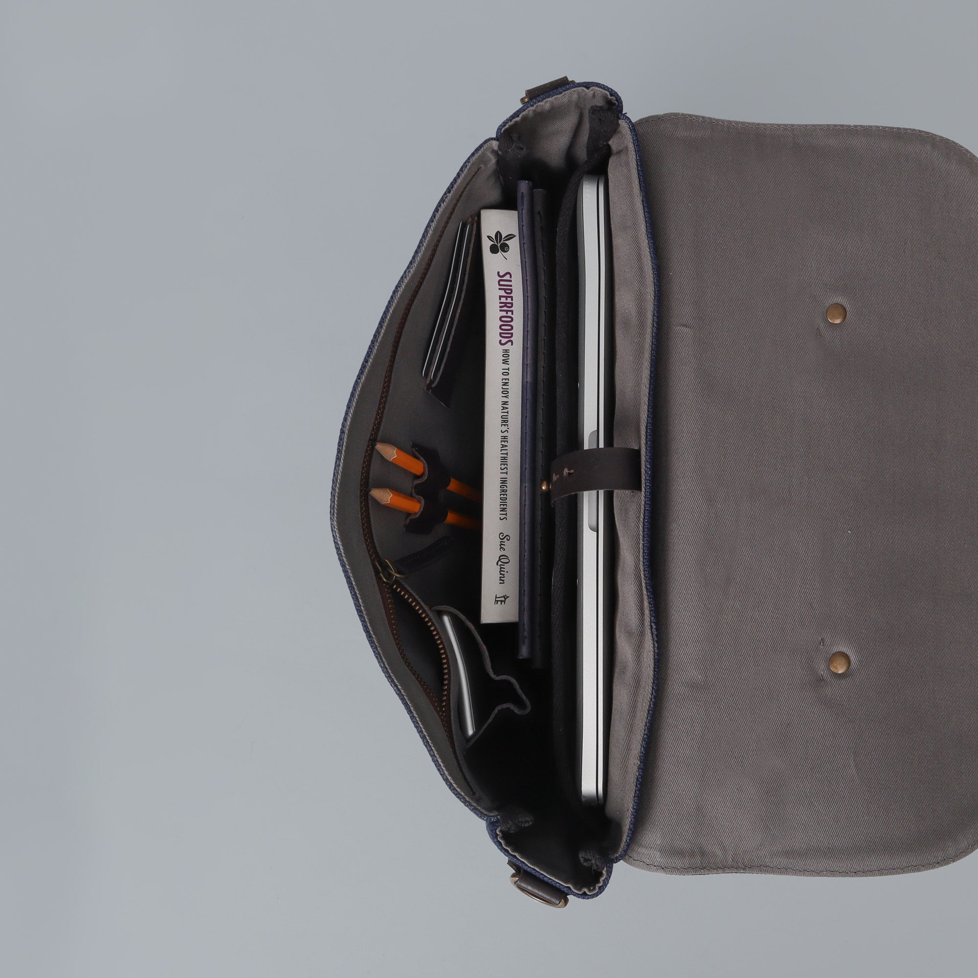 Oslo Canvas Briefcase showcasing its durable cotton canvas, leather straps, and multiple pockets for organization.