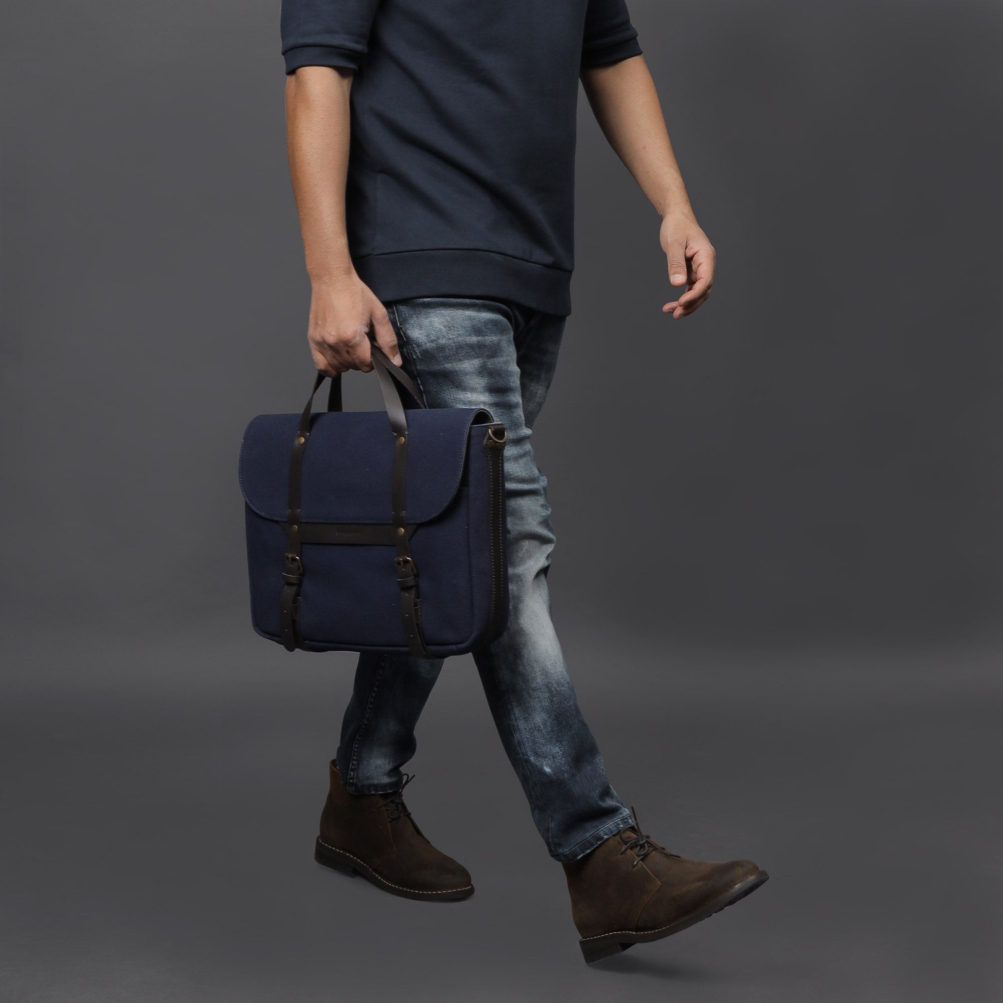 Oslo Canvas Briefcase showcasing its durable cotton canvas, leather straps, and multiple pockets for organization.