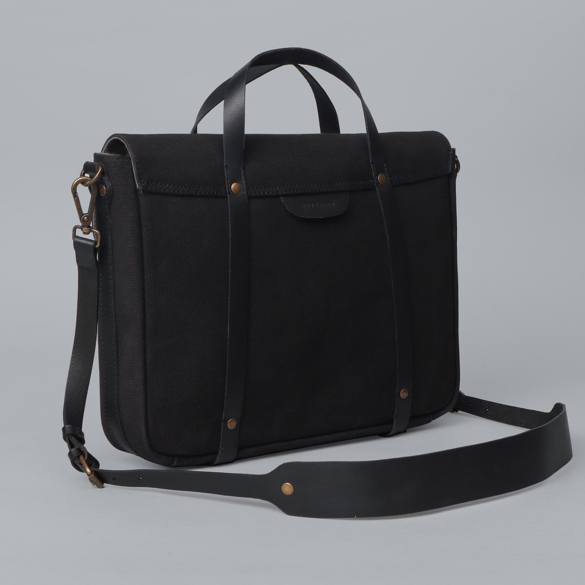 Oslo Canvas Briefcase showcasing its durable cotton canvas material and leather straps, designed for laptops up to 13 inches.