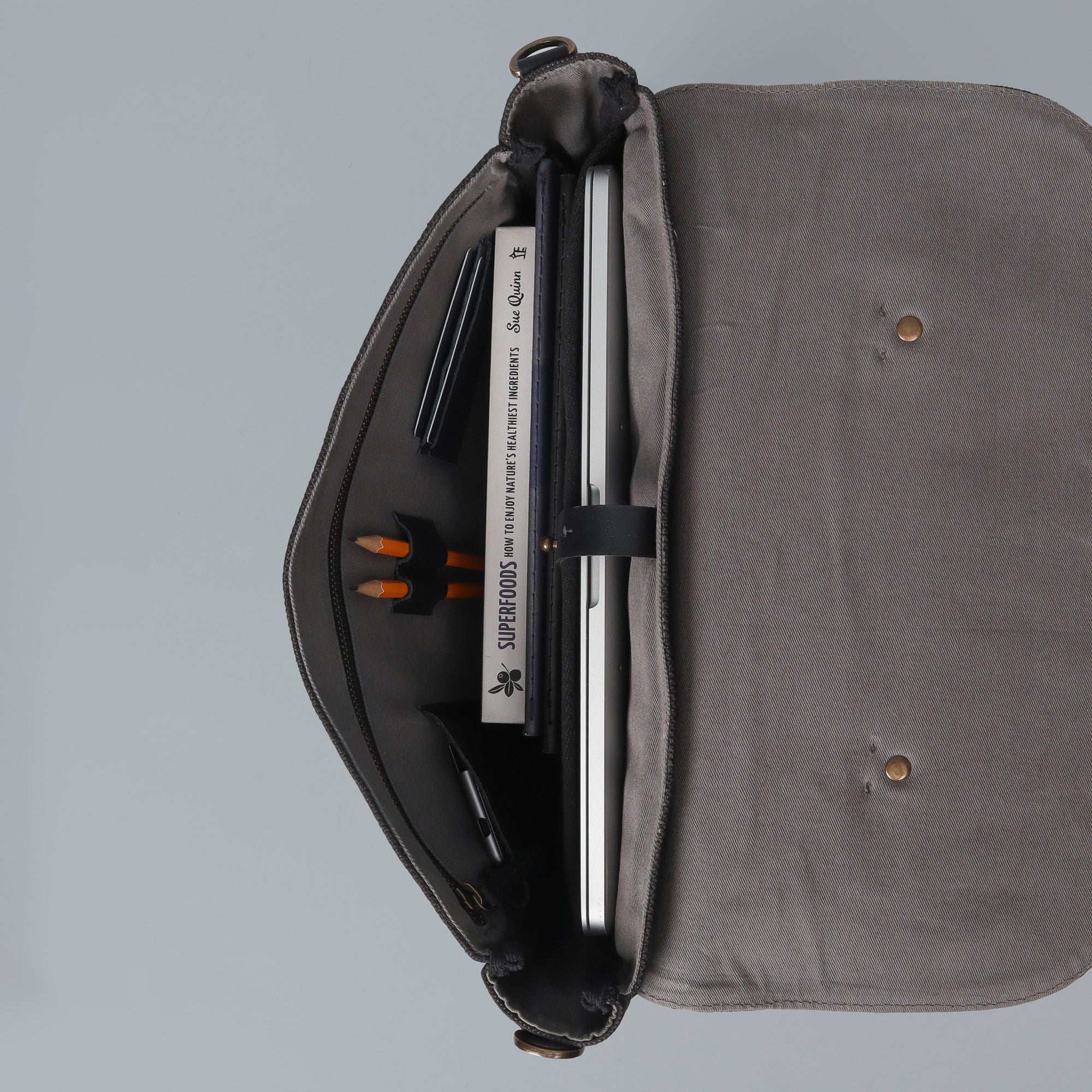 Oslo Canvas Briefcase showcasing its durable cotton canvas material and leather straps, designed for laptops up to 13 inches.