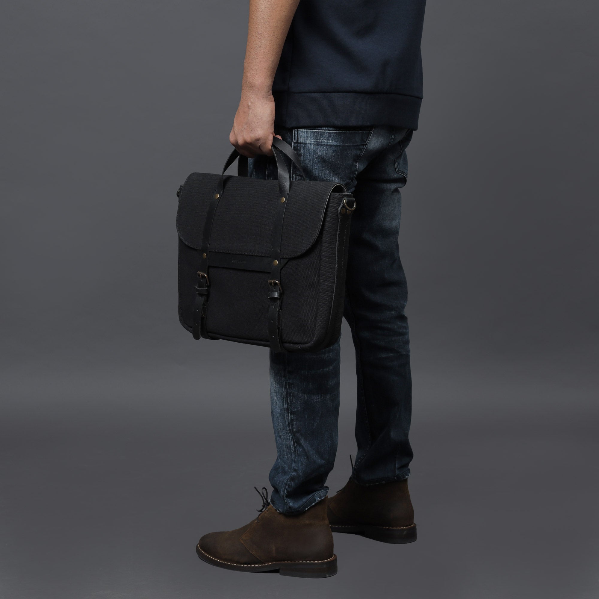 Oslo Canvas Briefcase showcasing its durable cotton canvas material and leather straps, designed for laptops up to 13 inches.