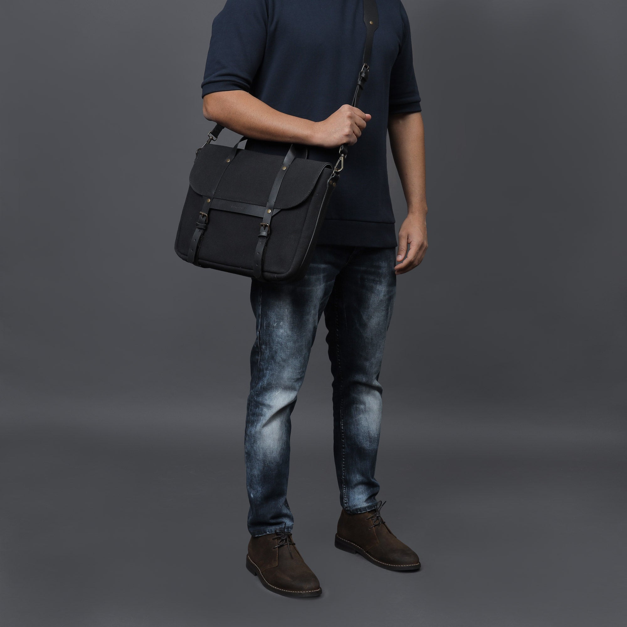 Oslo Canvas Briefcase showcasing its durable cotton canvas material and leather straps, designed for laptops up to 13 inches.