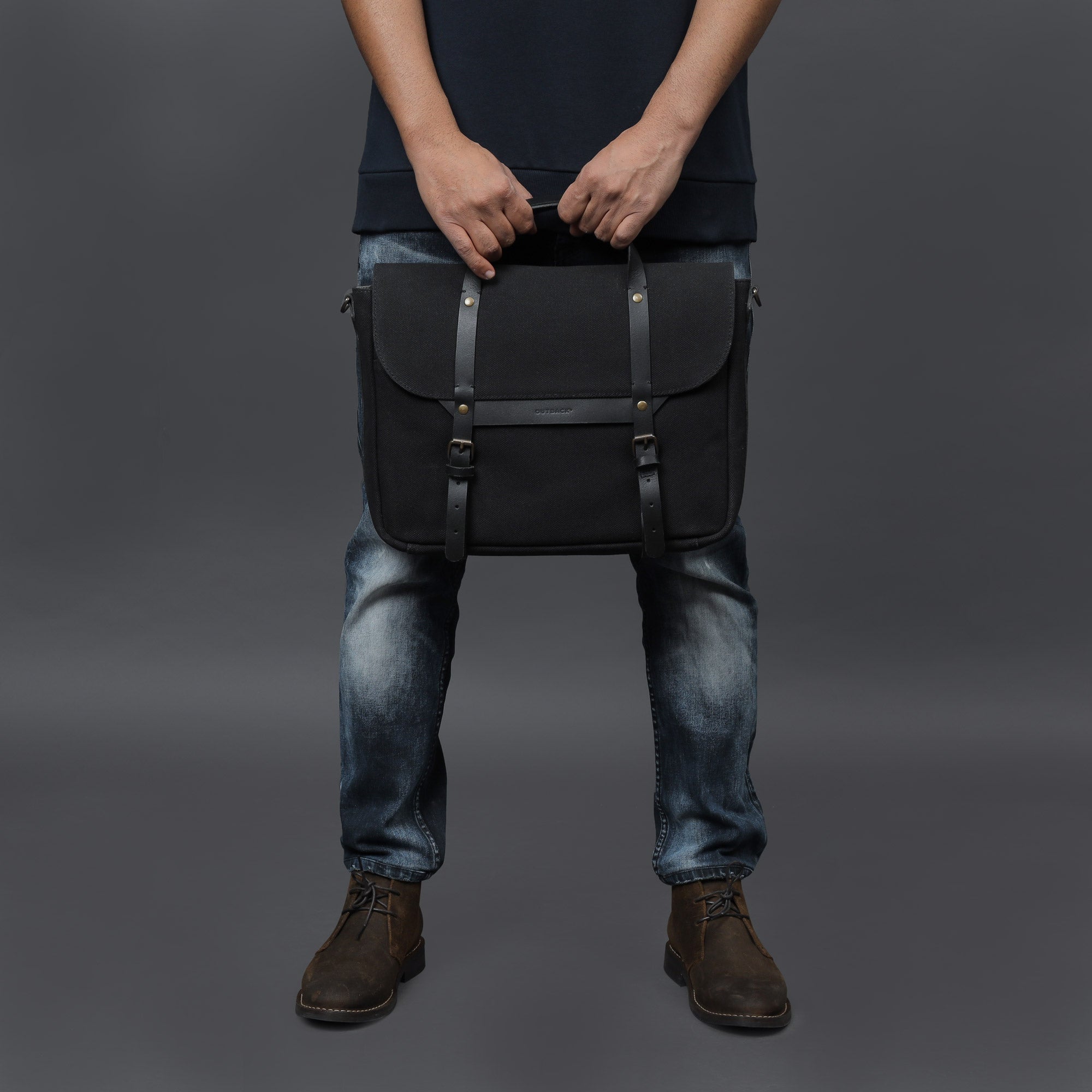 Oslo Canvas Briefcase showcasing its durable cotton canvas material and leather straps, designed for laptops up to 13 inches.