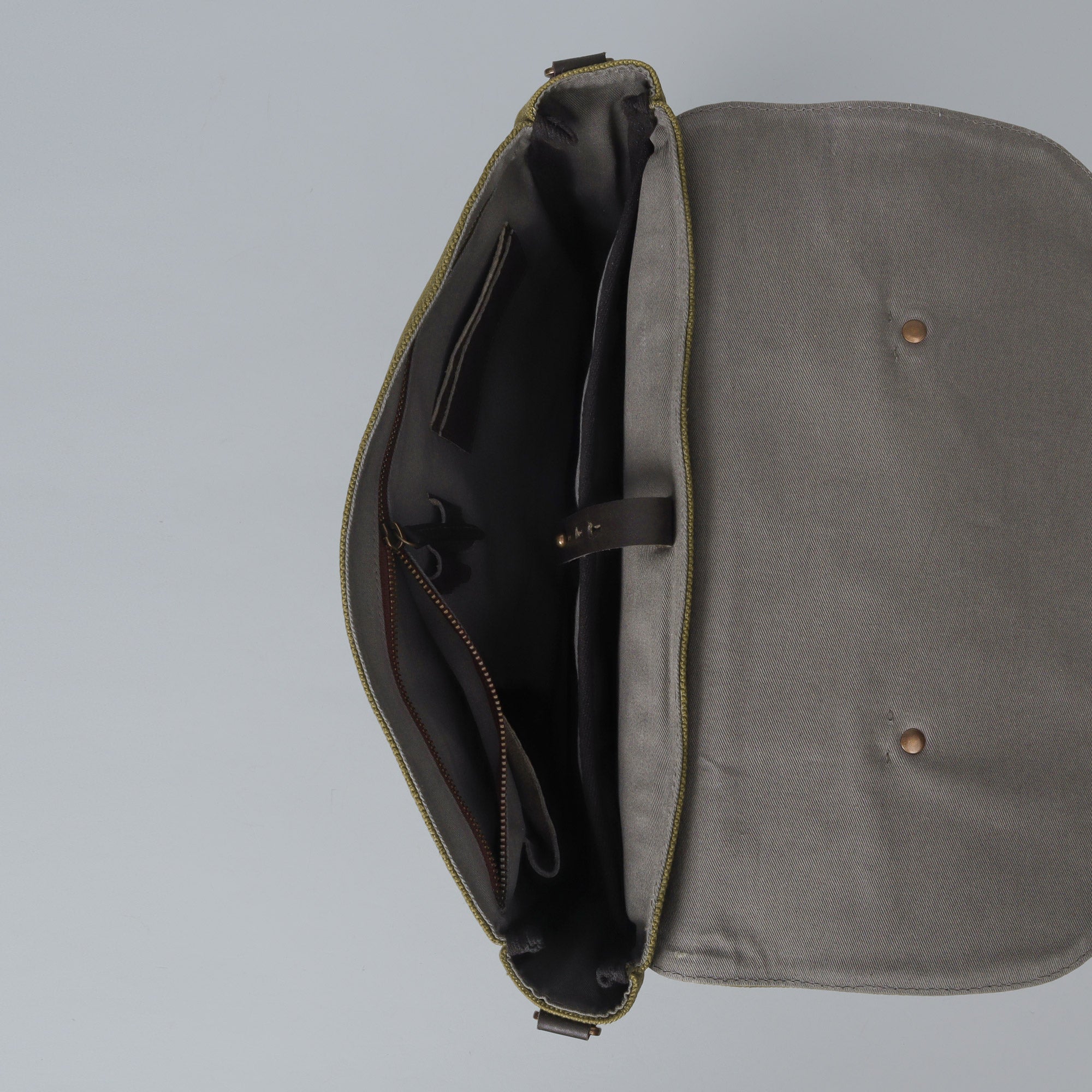 Oslo Canvas Briefcase made from durable cotton canvas, featuring leather straps and multiple pockets for organization, suitable for laptops up to 13 inches.